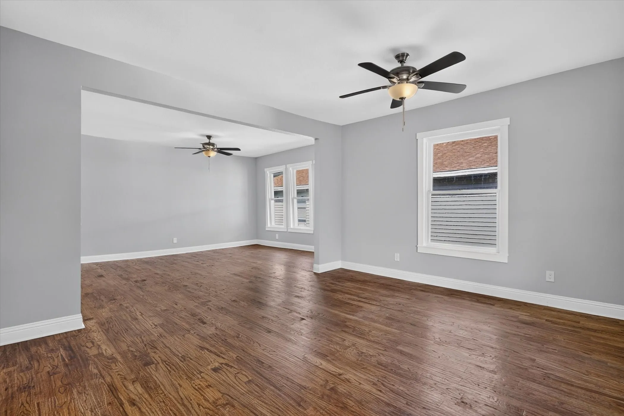 Spacious interior featuring wood-finish flooring, light gray wall tones, and bright white trim