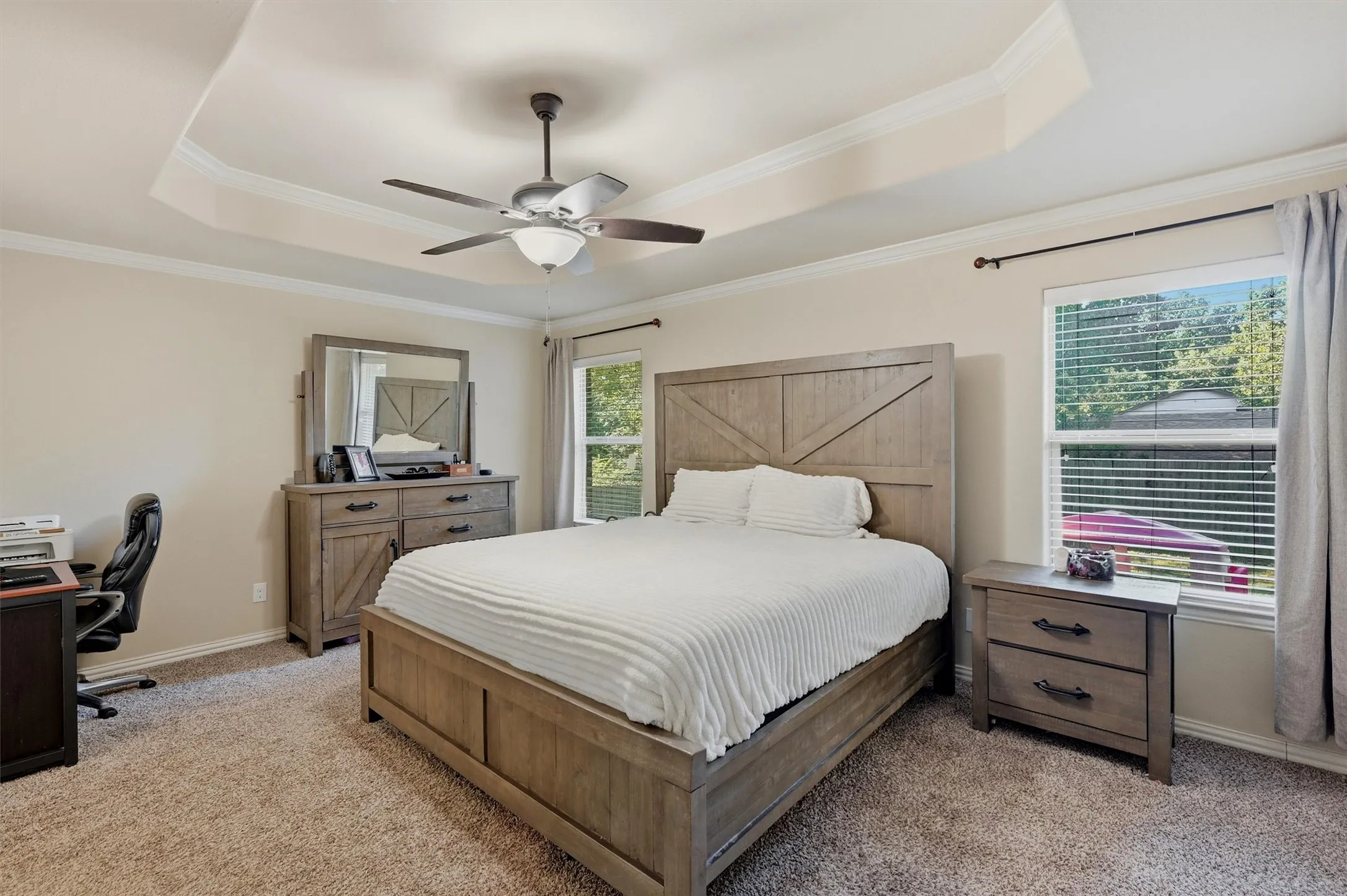 This is a great primary bedroom! It even has crown molding to match the home.