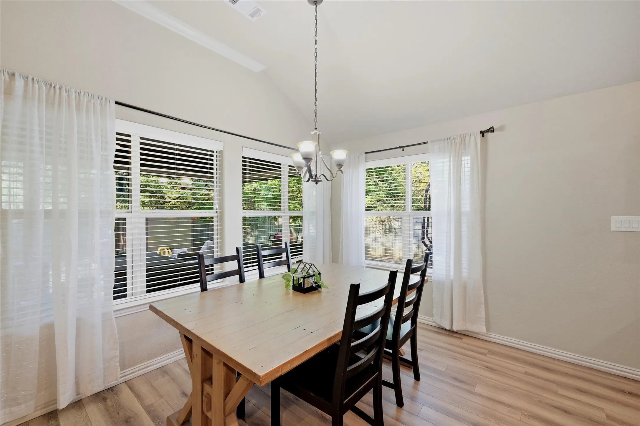 A dining area that is still private! The windows overlook the backyard which is fenced in.
