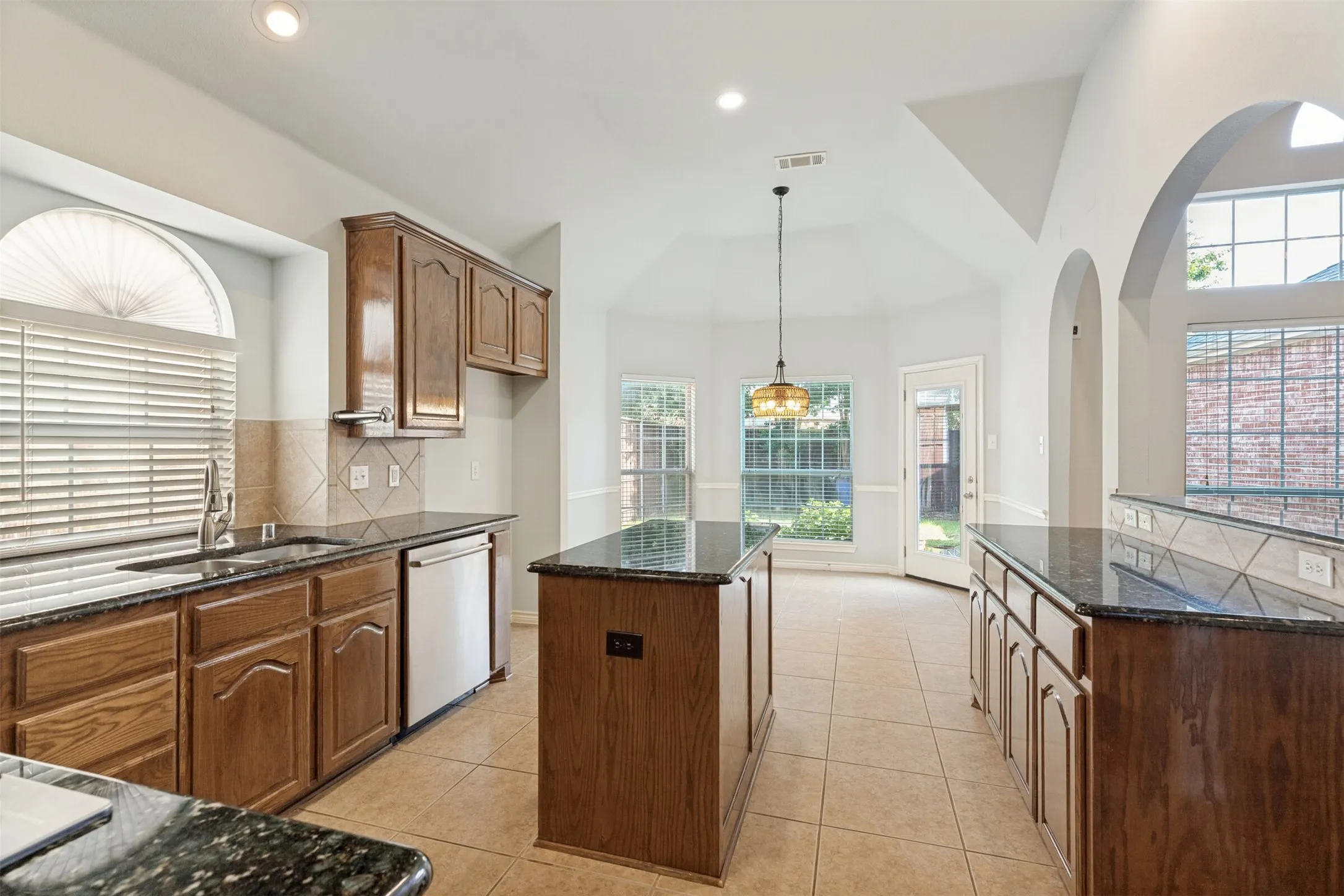 Kitchen opens to the breakfast nook and backyard