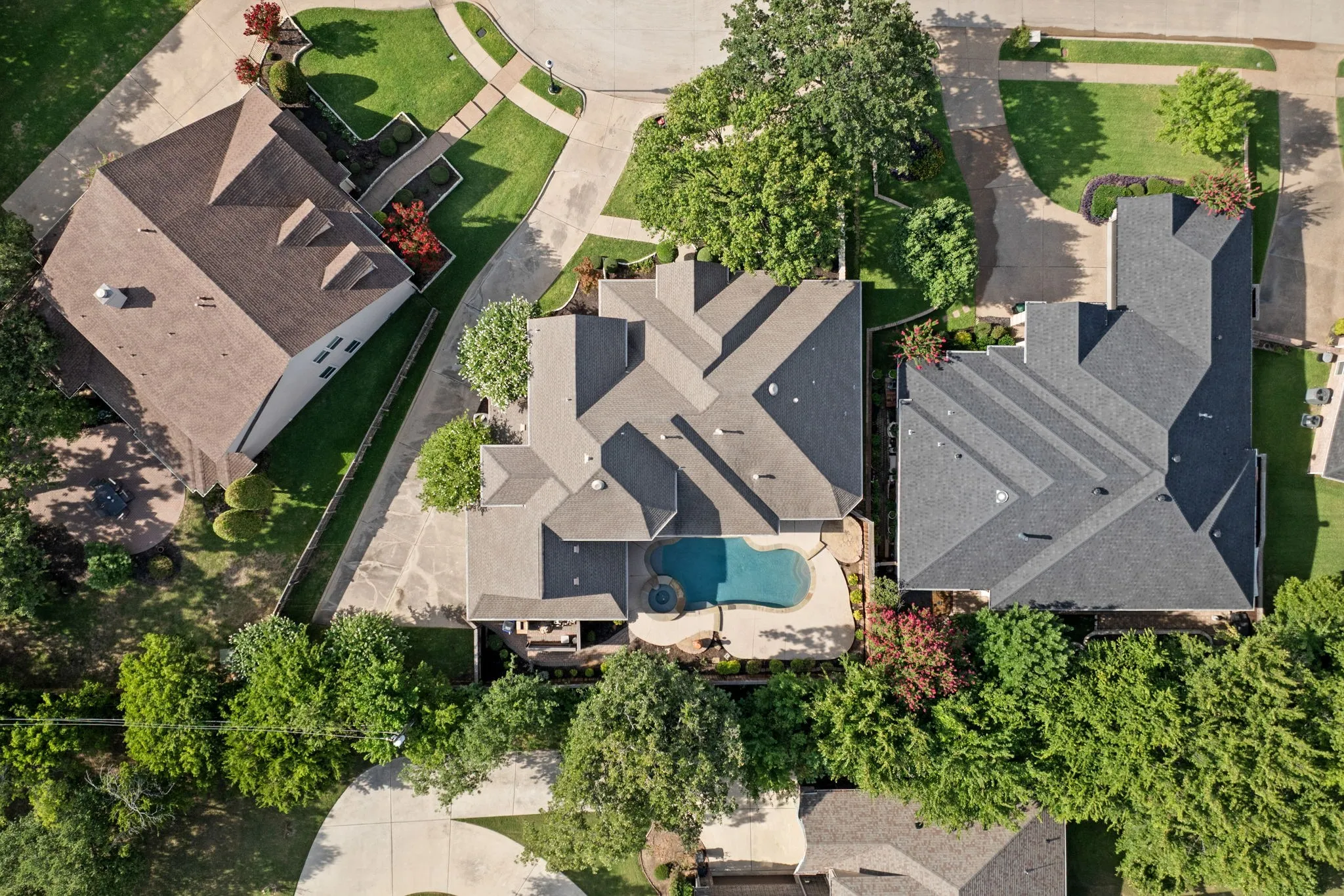 Expansive property featuring a large swimming pool, an integrated spa, and an attached covered patio