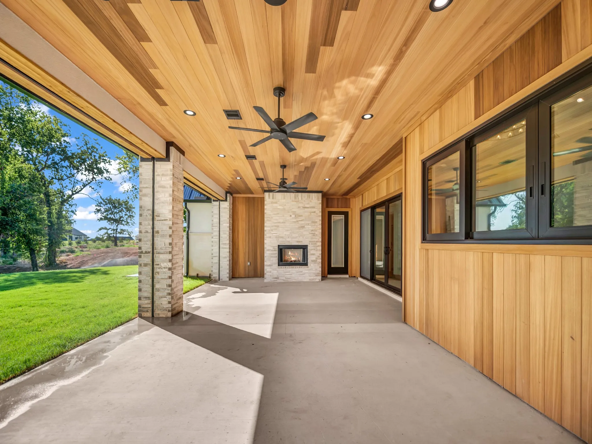 Stunning Thermoclad luxury wood showcasing natural tones of the wood. Wood burning fireplace and pass through window for easy hosting. Automated screens that lower and full HVAC system for patio to enjoy outdoors year-round.