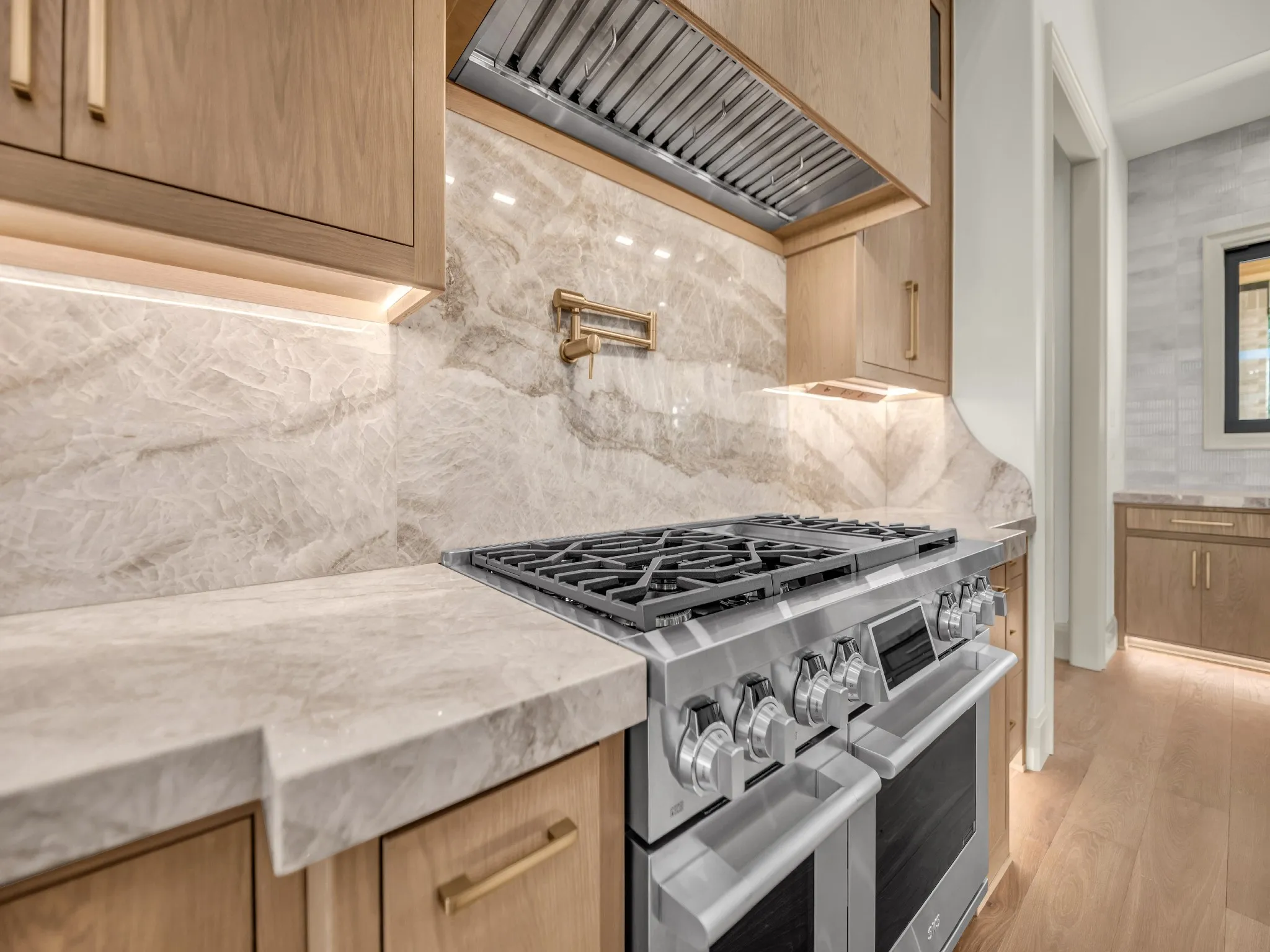 Built-in gas stove with pot filler and commercial grade vent.
