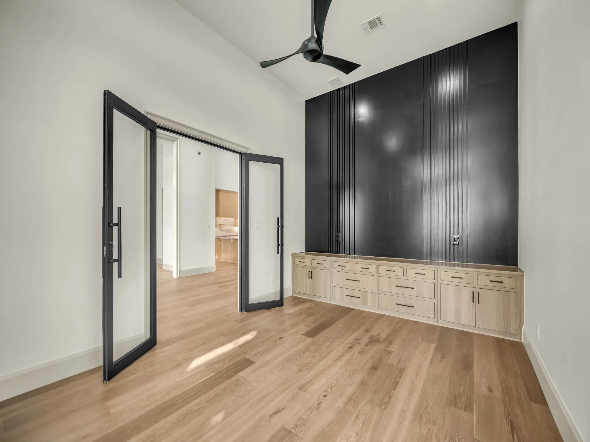 Large office located right off the entry way. With built in cabinets with a sophisticated accent wall.