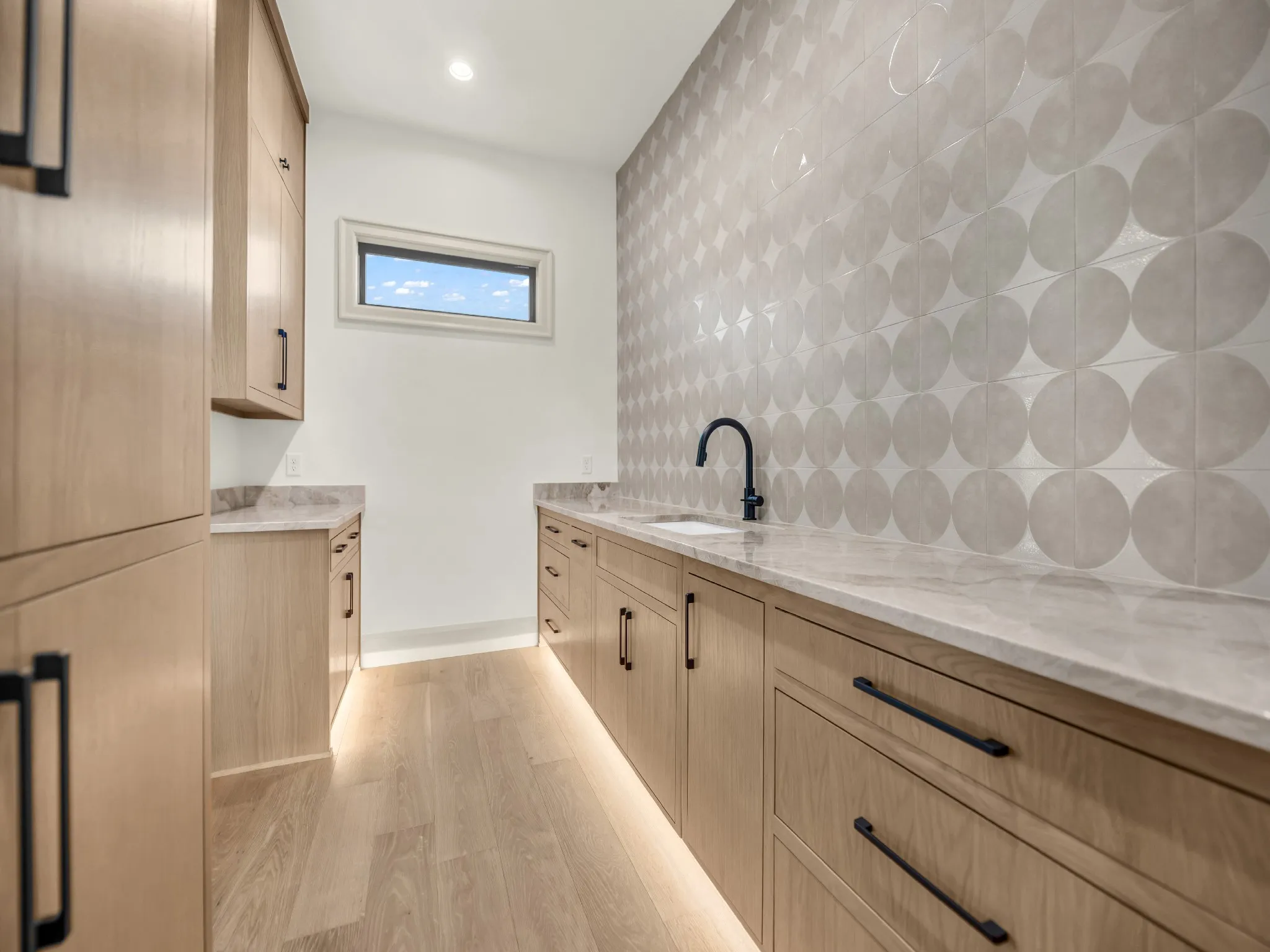 Prep-kitchen, with second sink and room for second refrigerator/freezer, located right off of the kitchen and formal dining room. Natural stone countertops continued and gorgeous back-splash up to the ceiling.