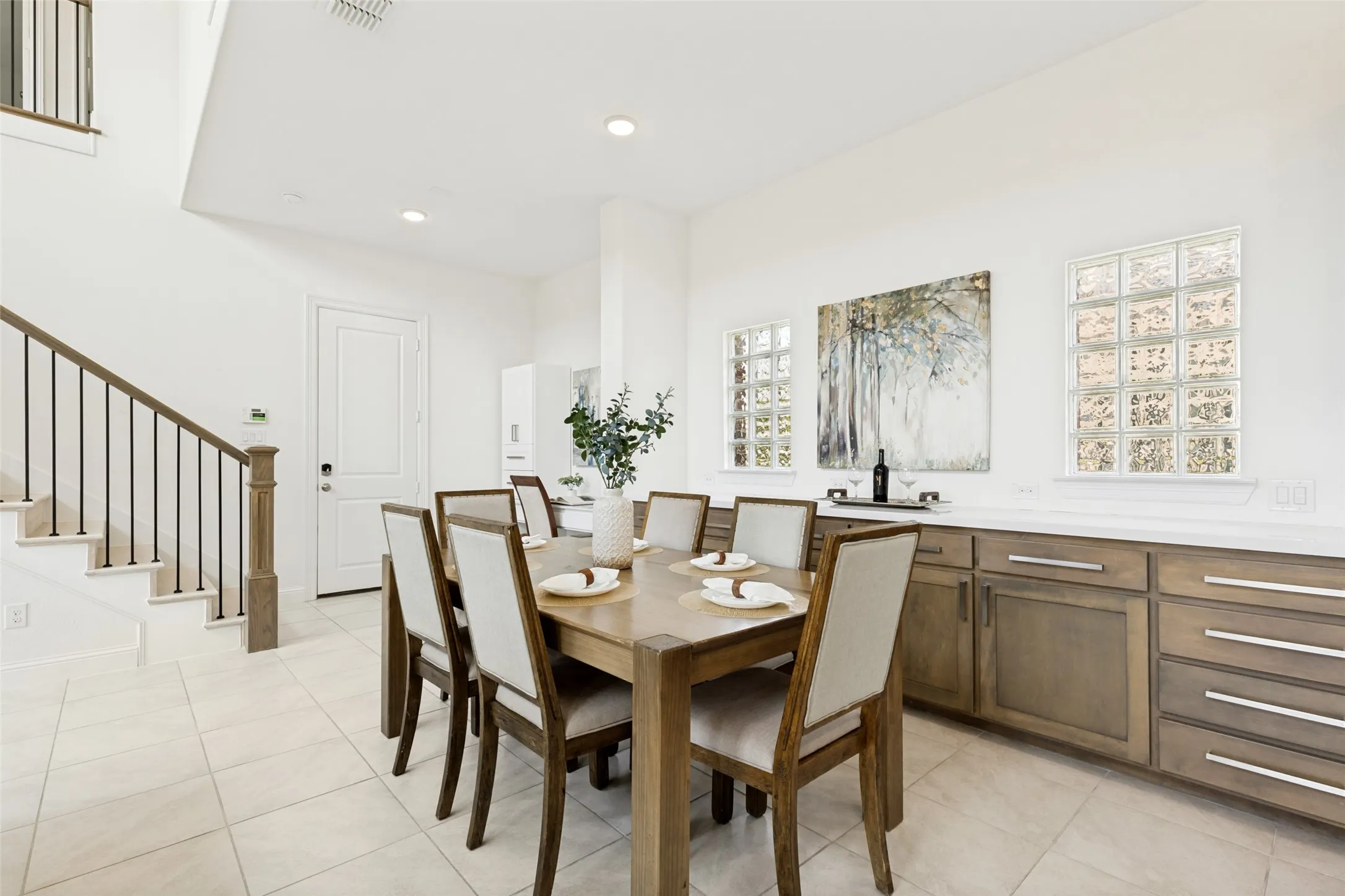 Dining area featuring recessed lighting, glass block windows, and built-in cabinetry with a light-toned countertop