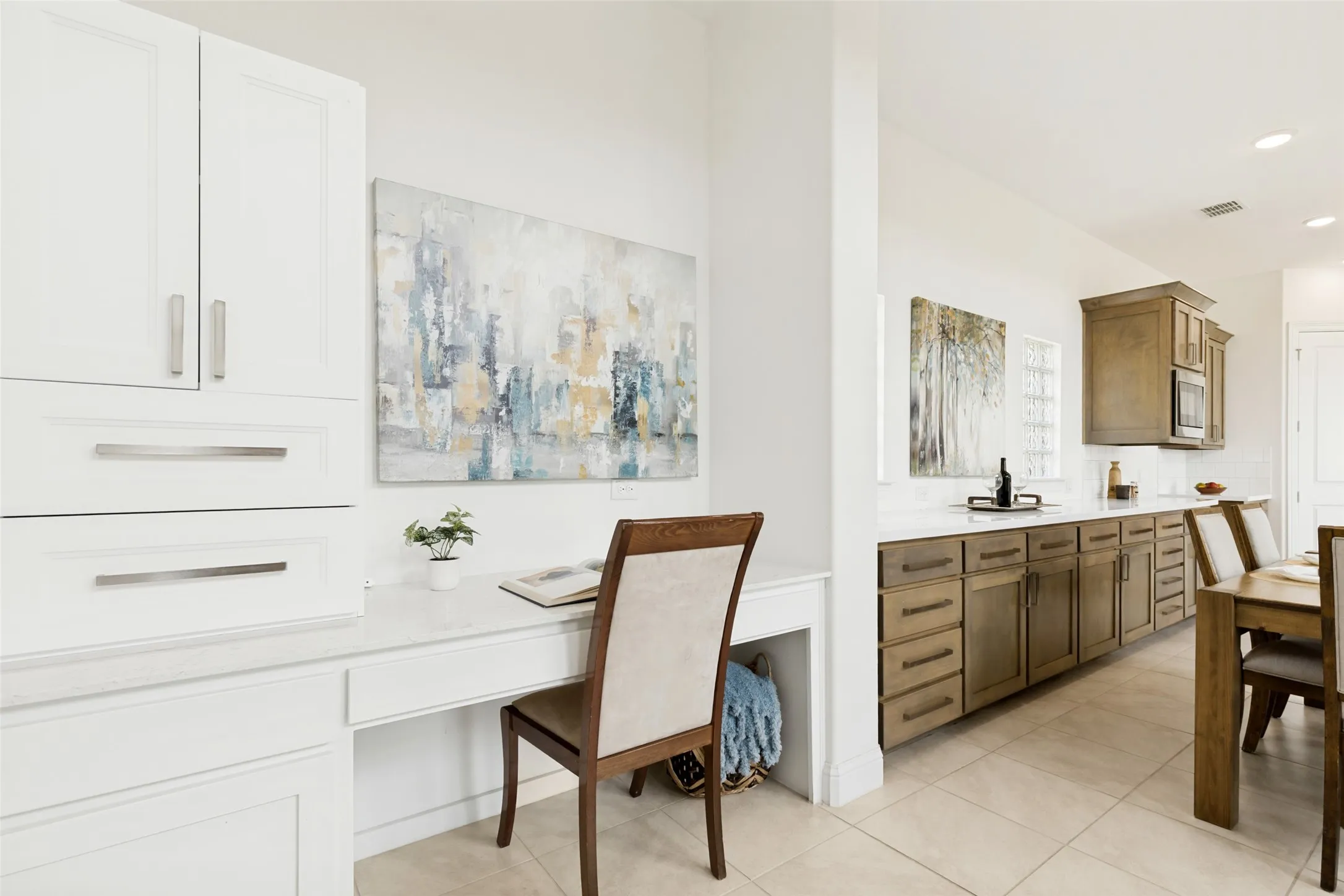 Integrated desk area featuring white cabinetry and a light-toned countertop