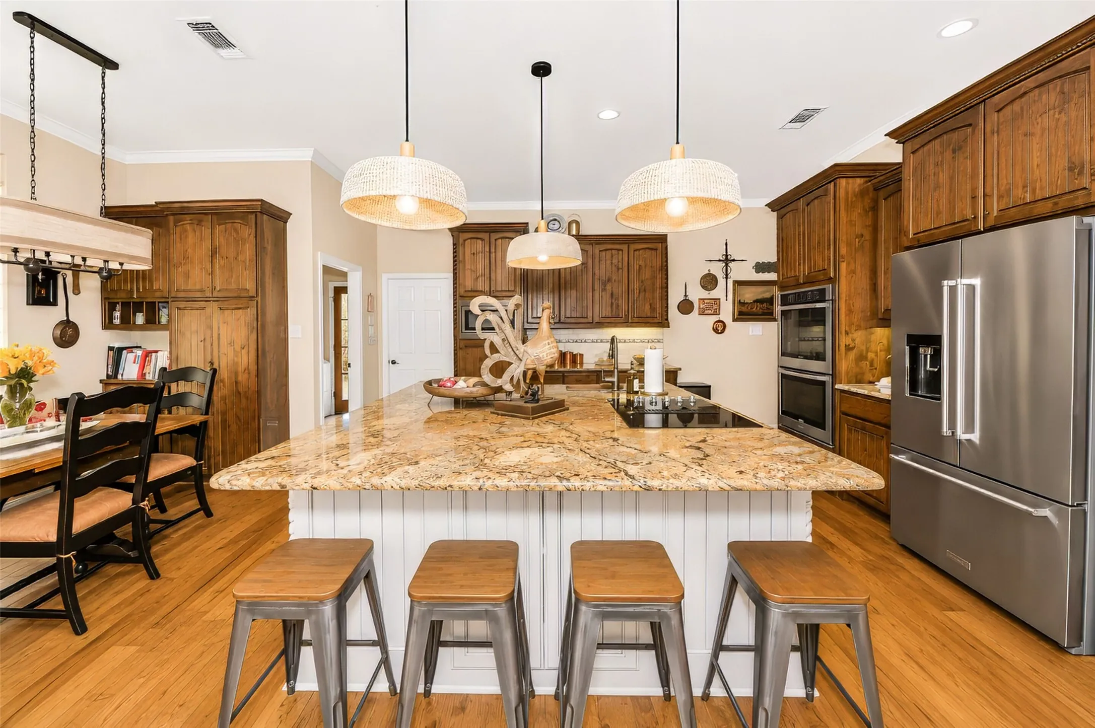 Kitchen area features custom cabinetry and huge island with seating and storage.