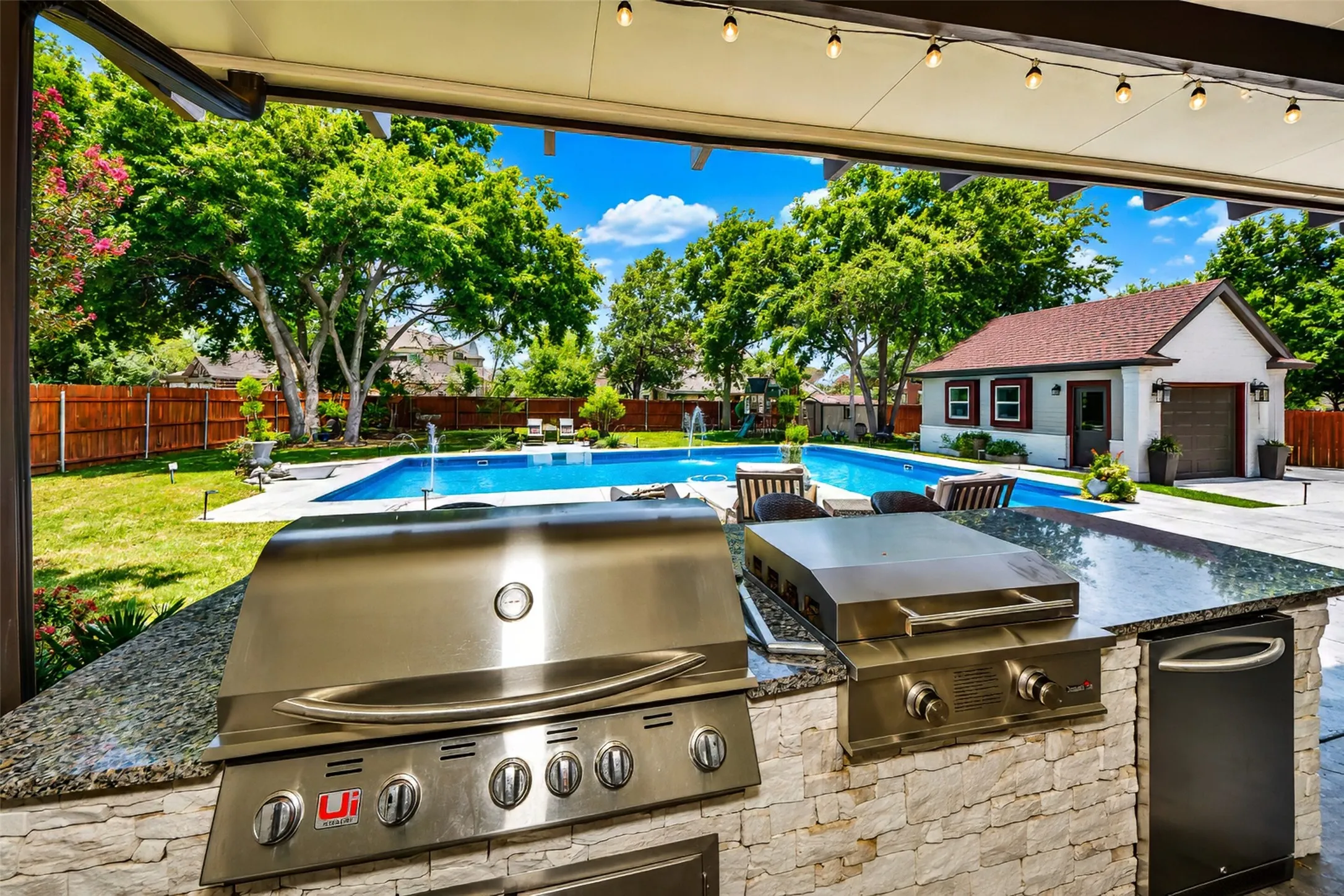 From the outdoor kitchen looking toward pool and patio.