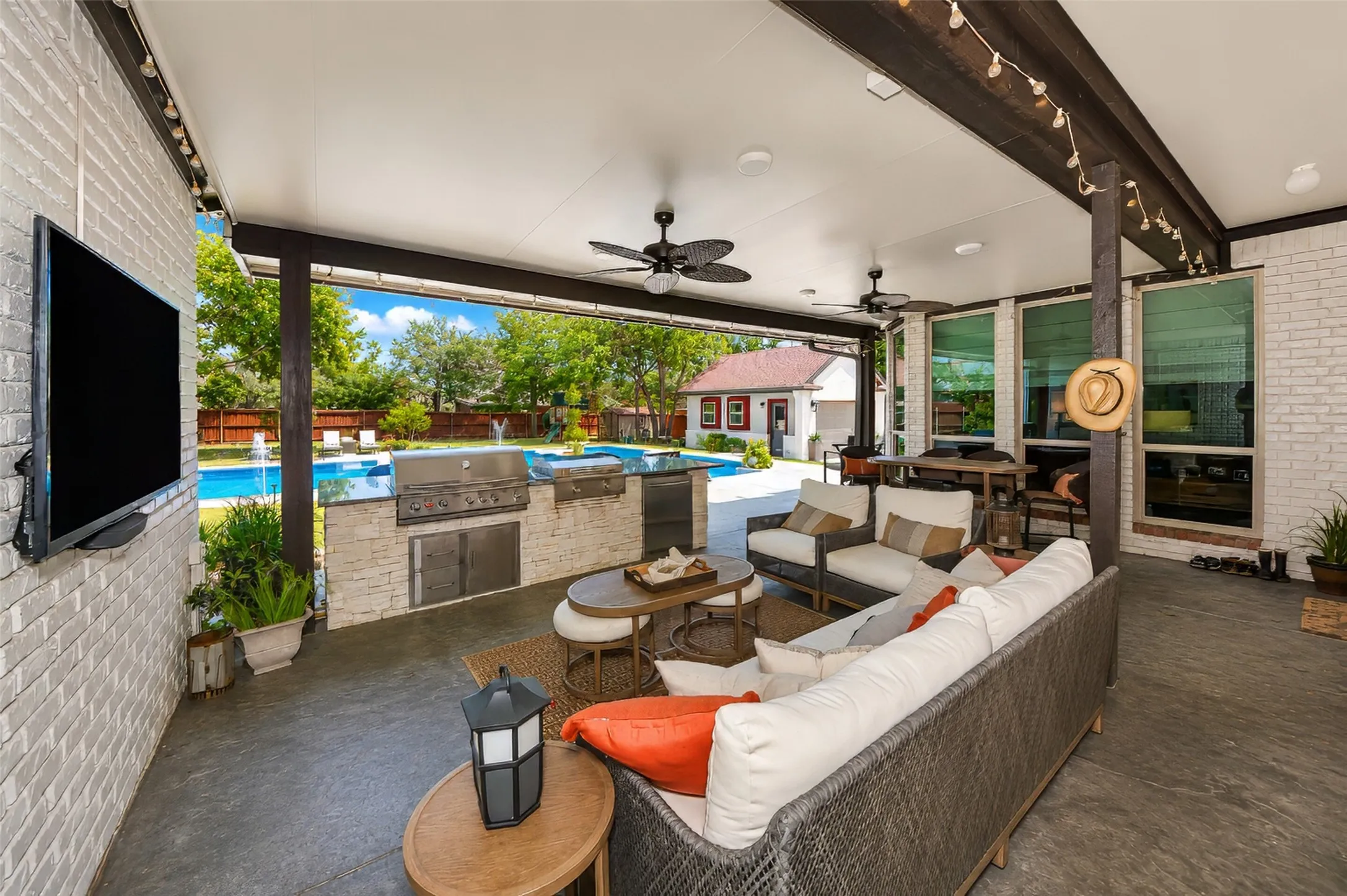 Expansive covered patio with fans, lighting and television.