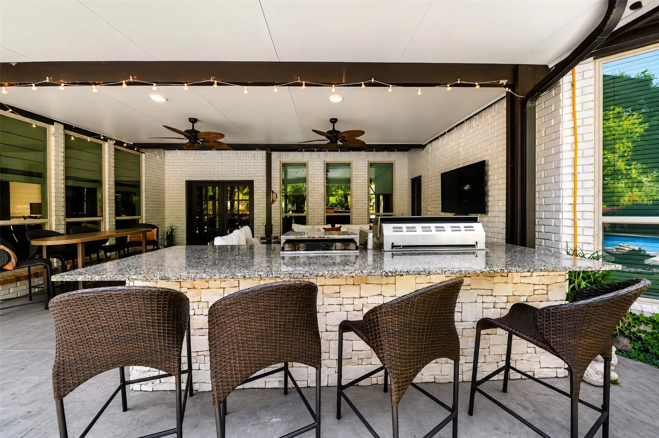 Expansive covered patio and outdoor kitchen/bar area.