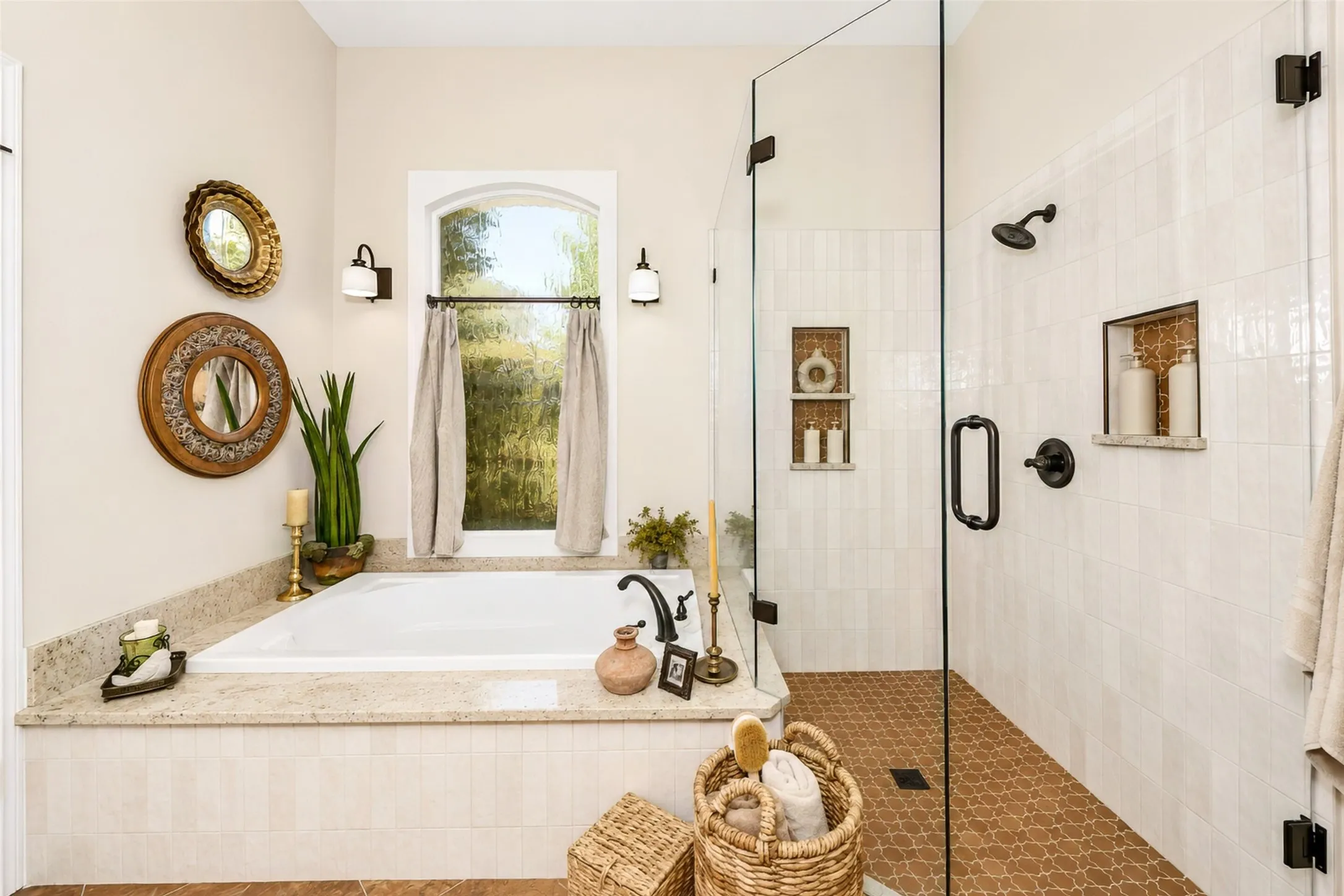 Primary bathroom has been newly remodeled with a gorgeous walk in shower, frameless glass enclosure and soaking tub, highlighted by a custom Pella window with textured glass.