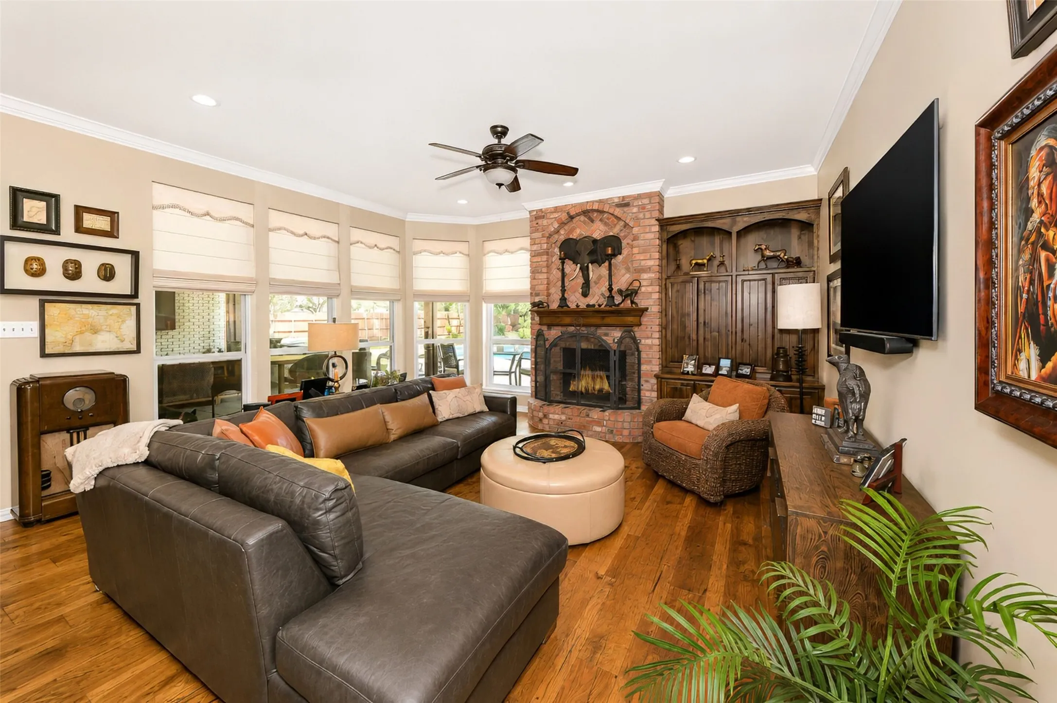The family room with a wall of windows overlooking patio and back yard.