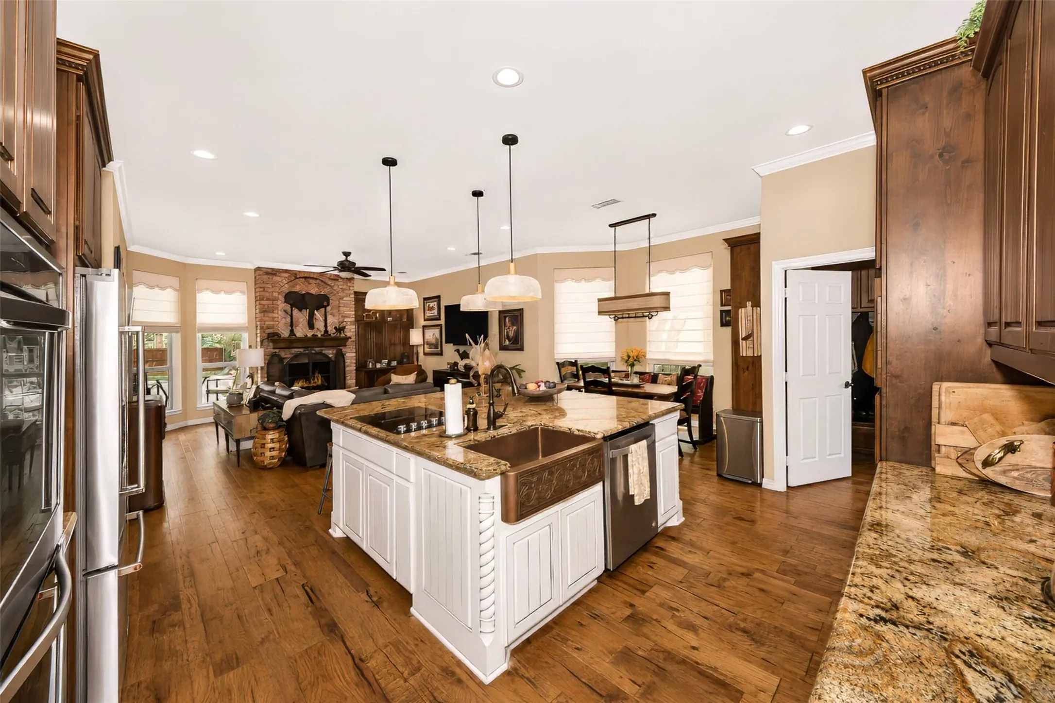 Another kitchen view. Kitchen features double ovens, glass cook top with downdraft ventilation, and a separate built in microwave.