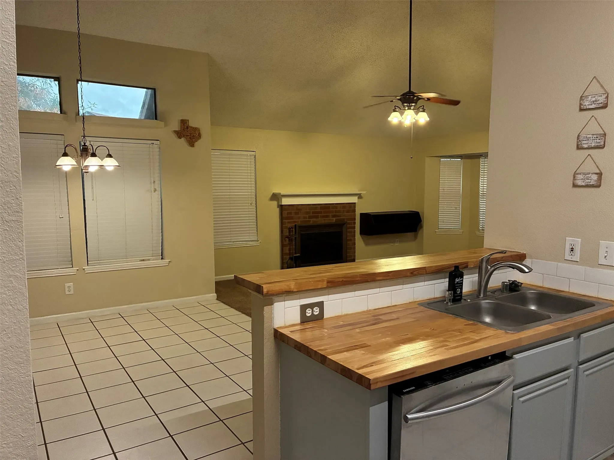 Kitchen with wood-finish countertops, stainless steel sink, and​​‌​​​​‌​​‌‌​‌‌​​​‌‌​‌​‌​‌​​​‌​​ dishwasher