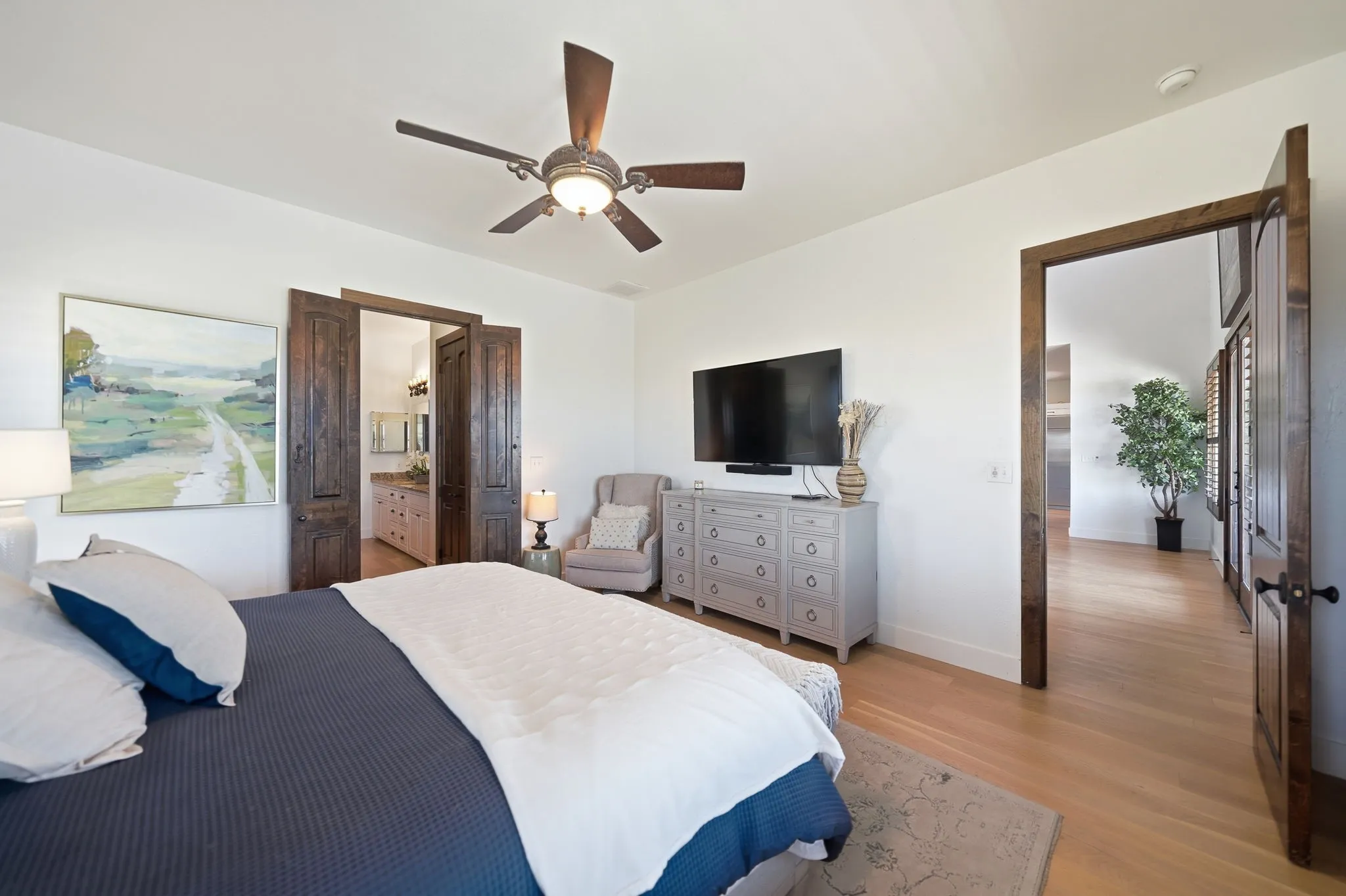 Primary Bedroom featuring wood-finish flooring and a ceiling fan with integrated lighting