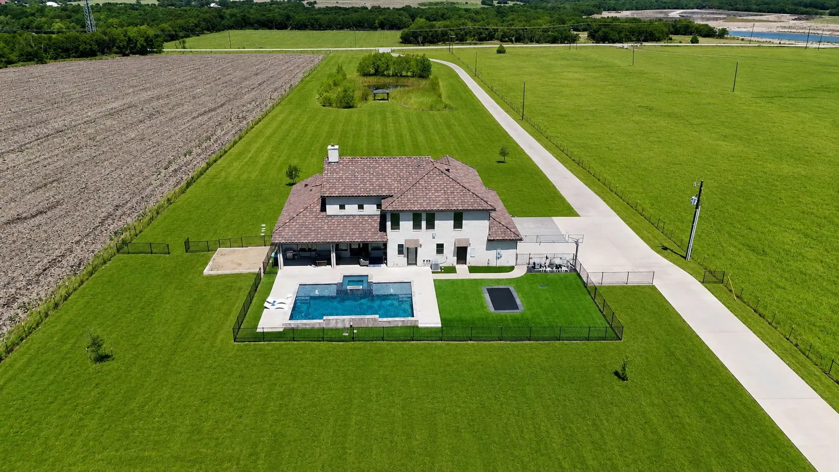 Contemporary-style residence featuring a tile roof and light-colored siding