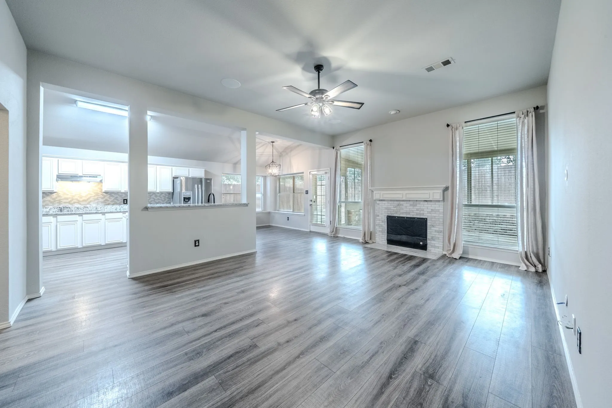 Open concept home with the living room opening to the kitchen and breakfast area. The wood-burning fireplace is perfect for gathering family and friends!