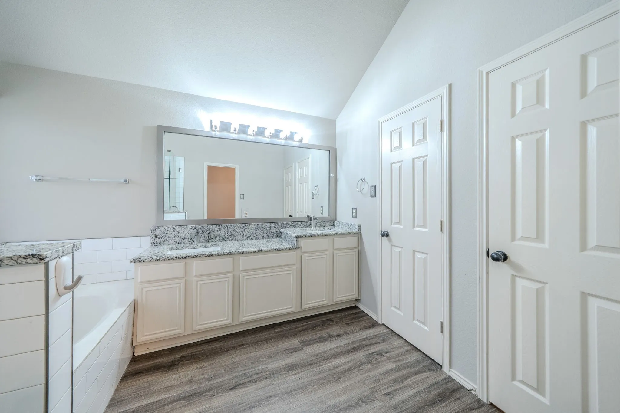 The primary bath features a multilevel dual sink vanity
