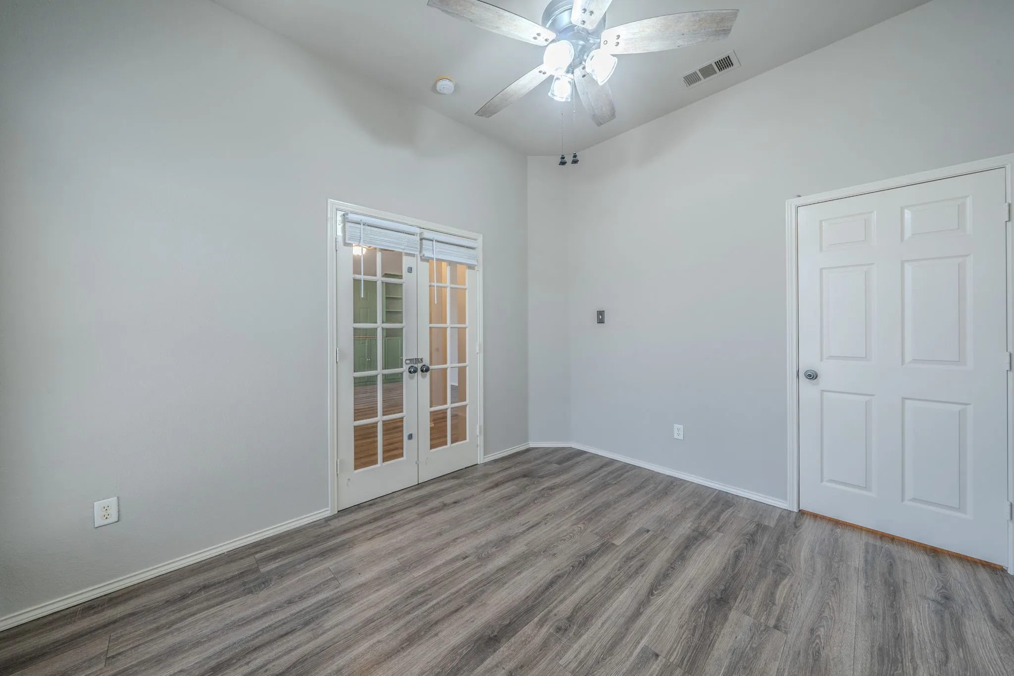 French doors just off the entry way lead into the home office