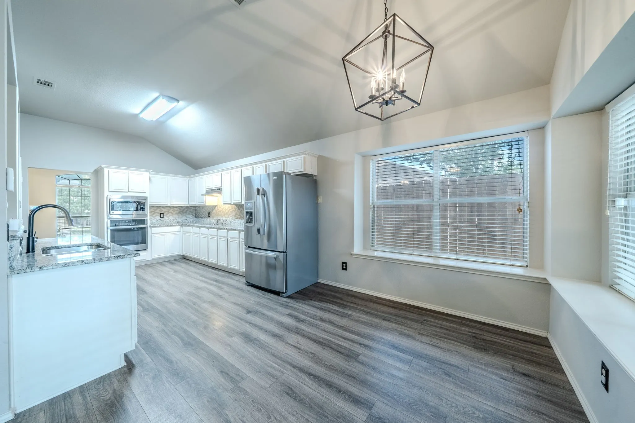The large breakfast area enjoys large bay windows and lots of natural light