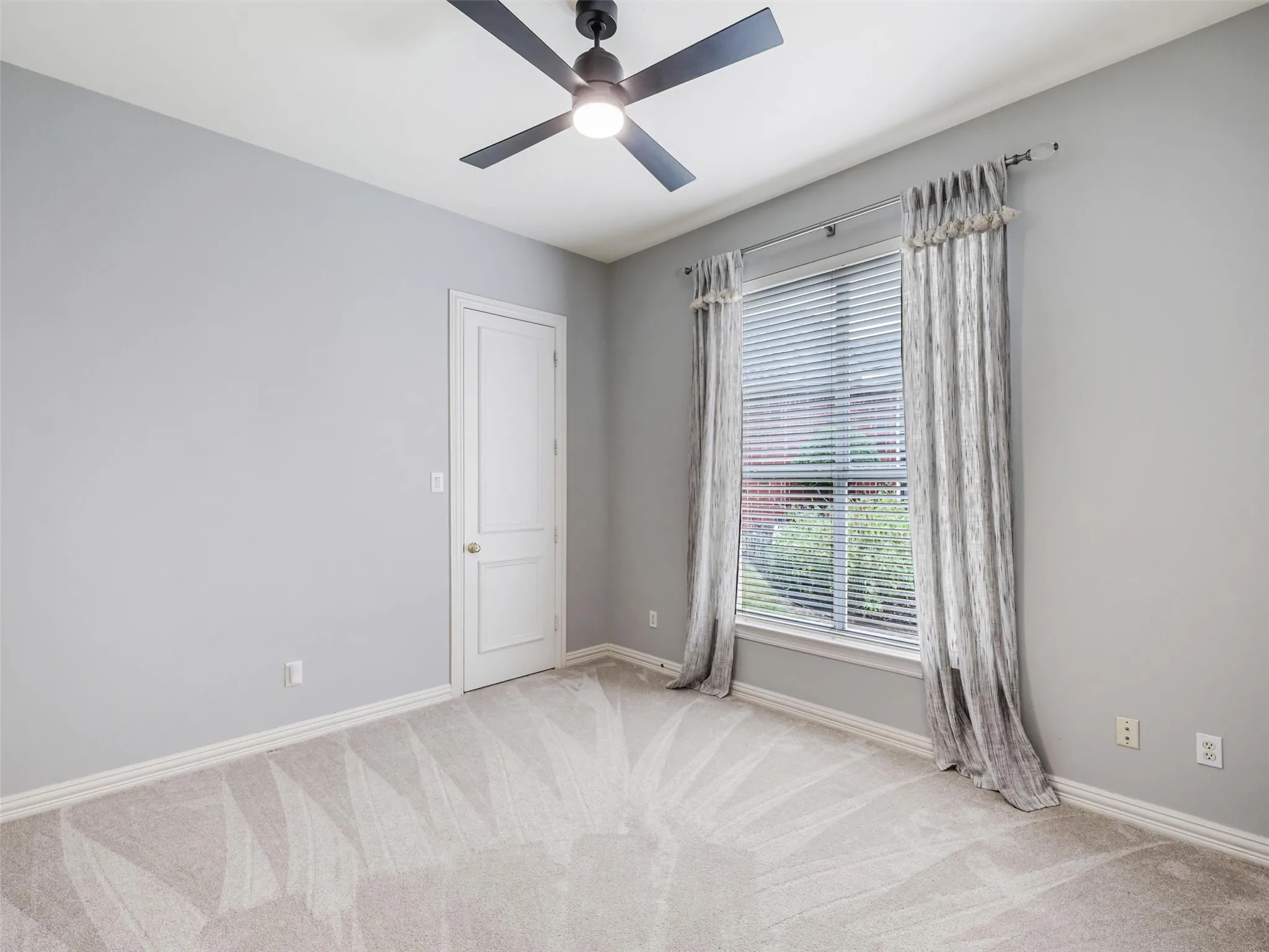 Recessed window with blinds and decorative drapery