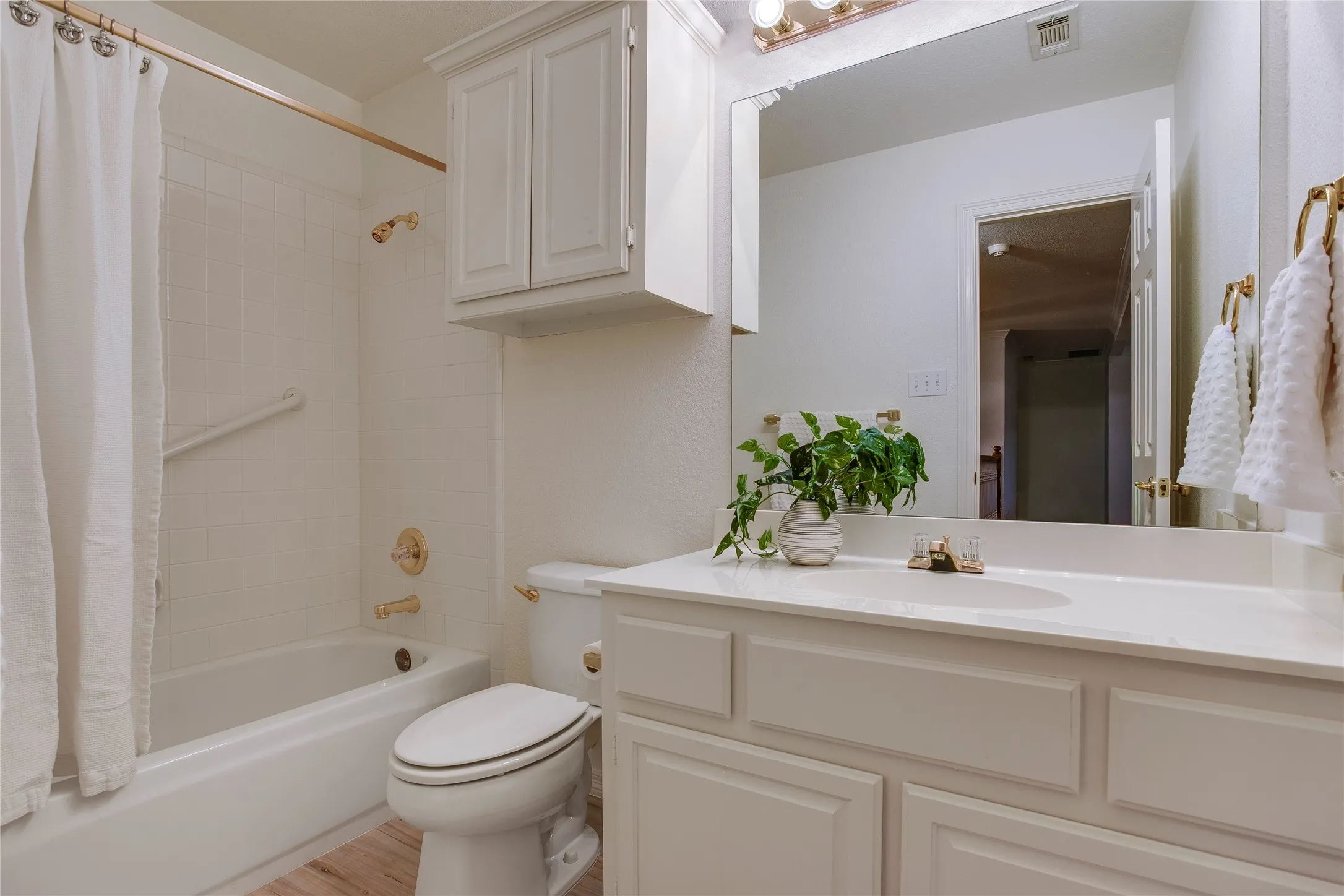 There are two full baths down and two up. This the bath at the top of the stairs adjacent to Bedroom #2