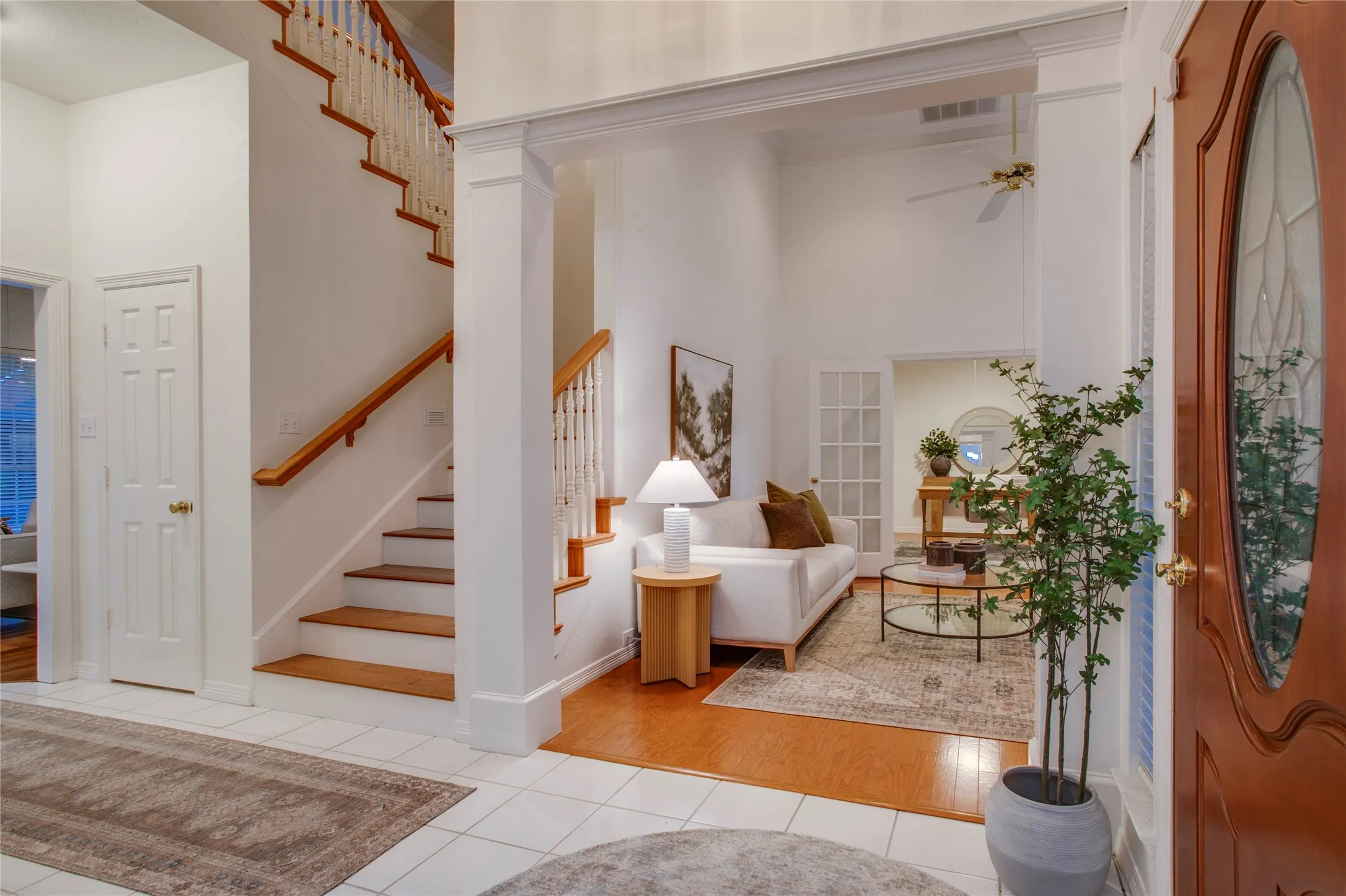 The staircase is open and the treads are wood with painted risers.