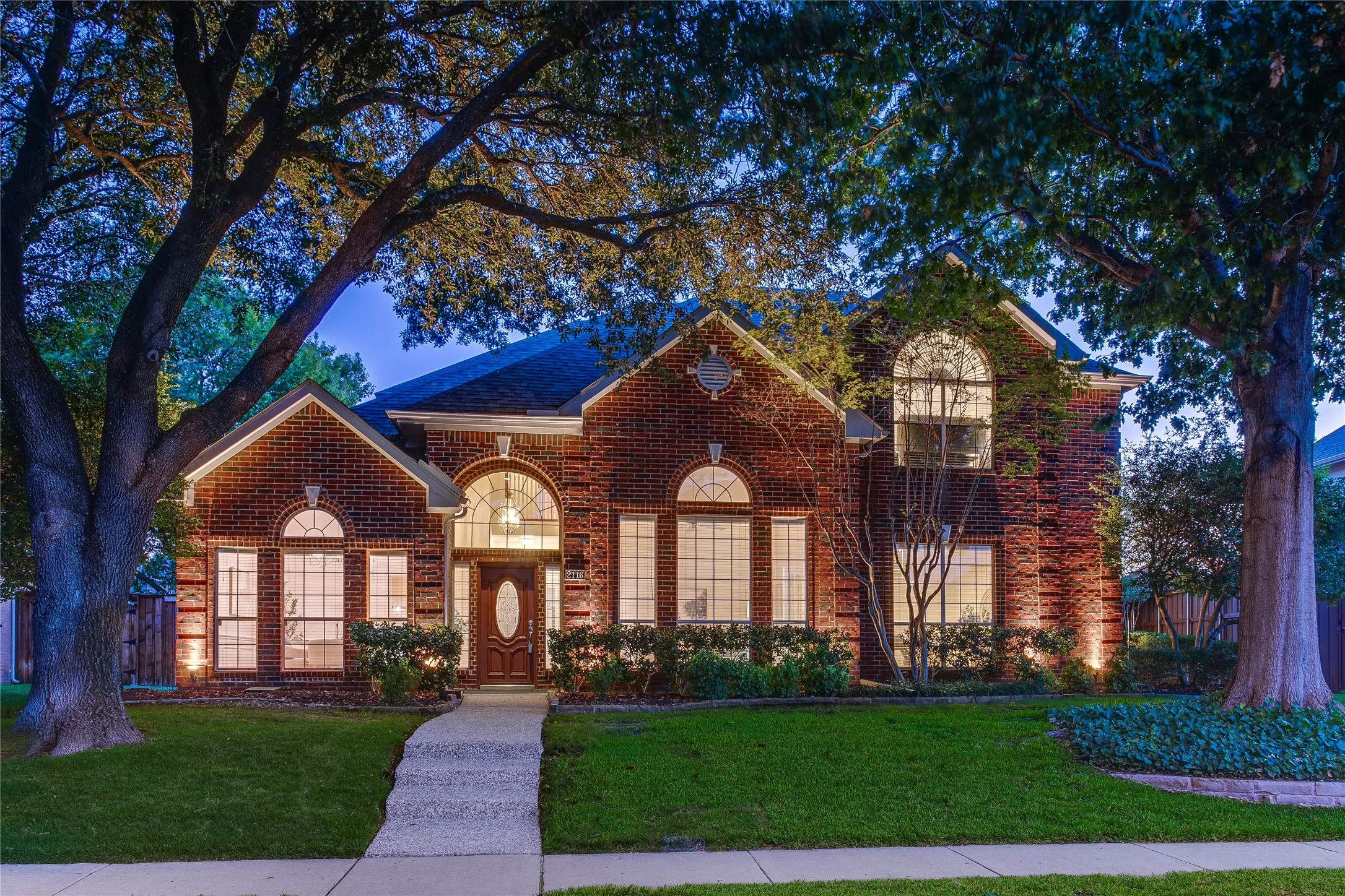The lawn is fully sprinklered and the towering trees provide cooling shade.