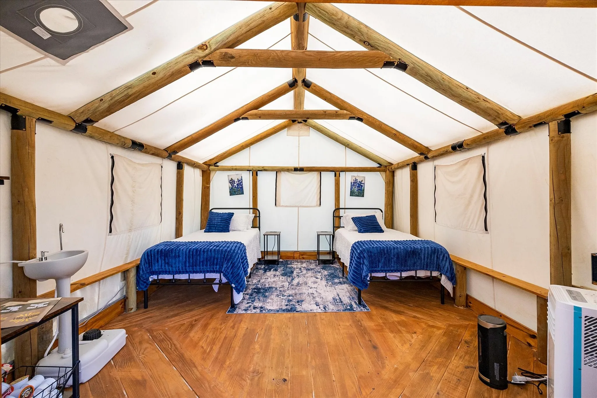 The Bluebonnet - Glamping tent interior with portable sink and AC.