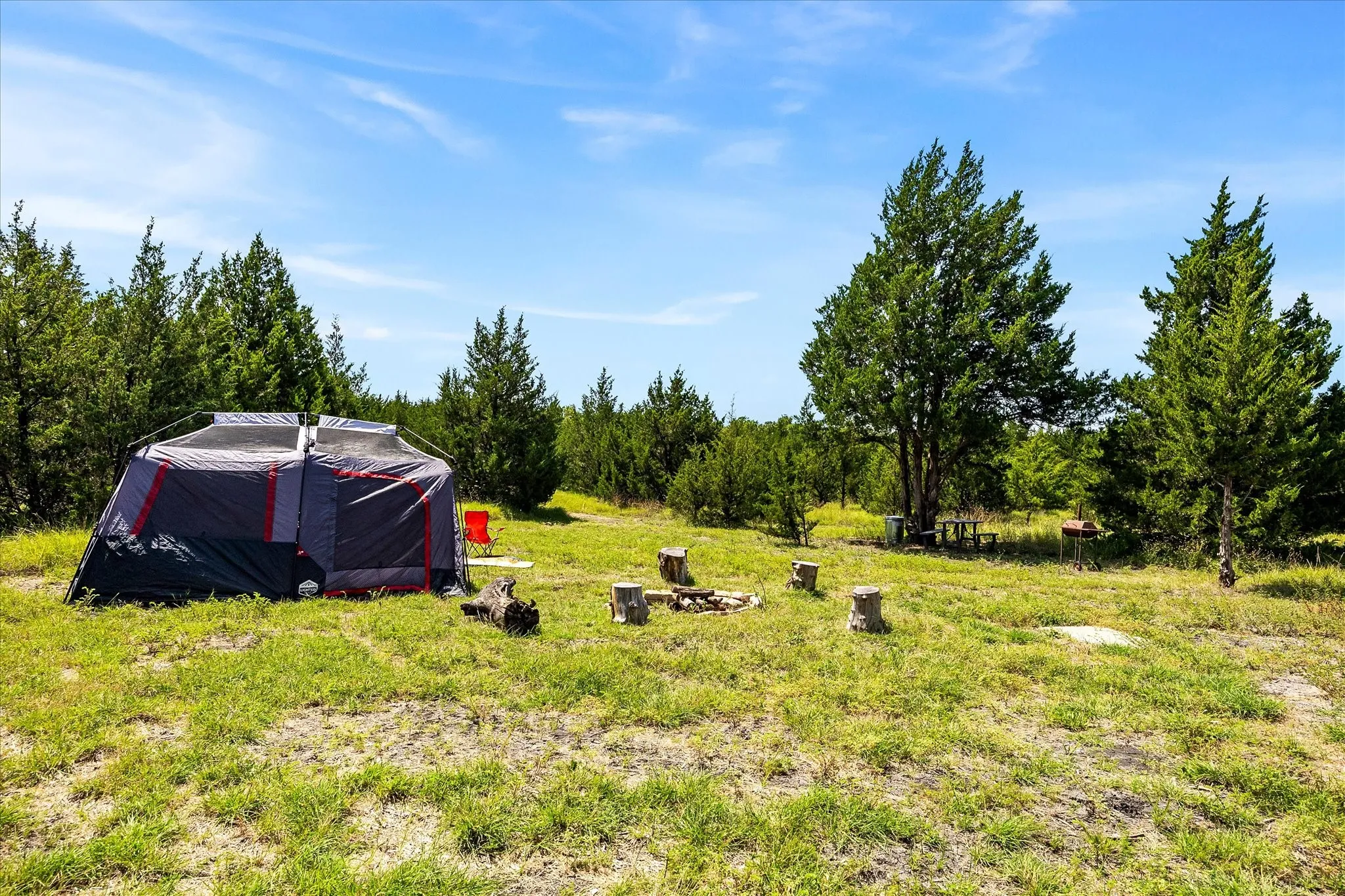 Primitive tent camping site with picnic table, grill and fire circle.