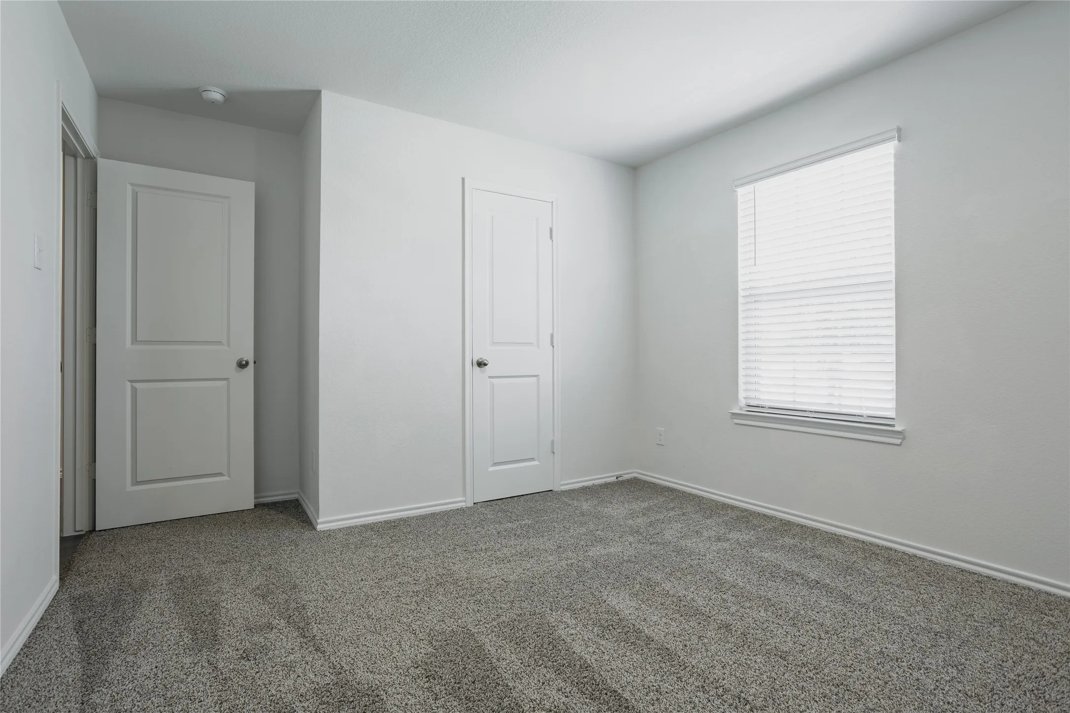Neutral color palette with textured gray carpeting