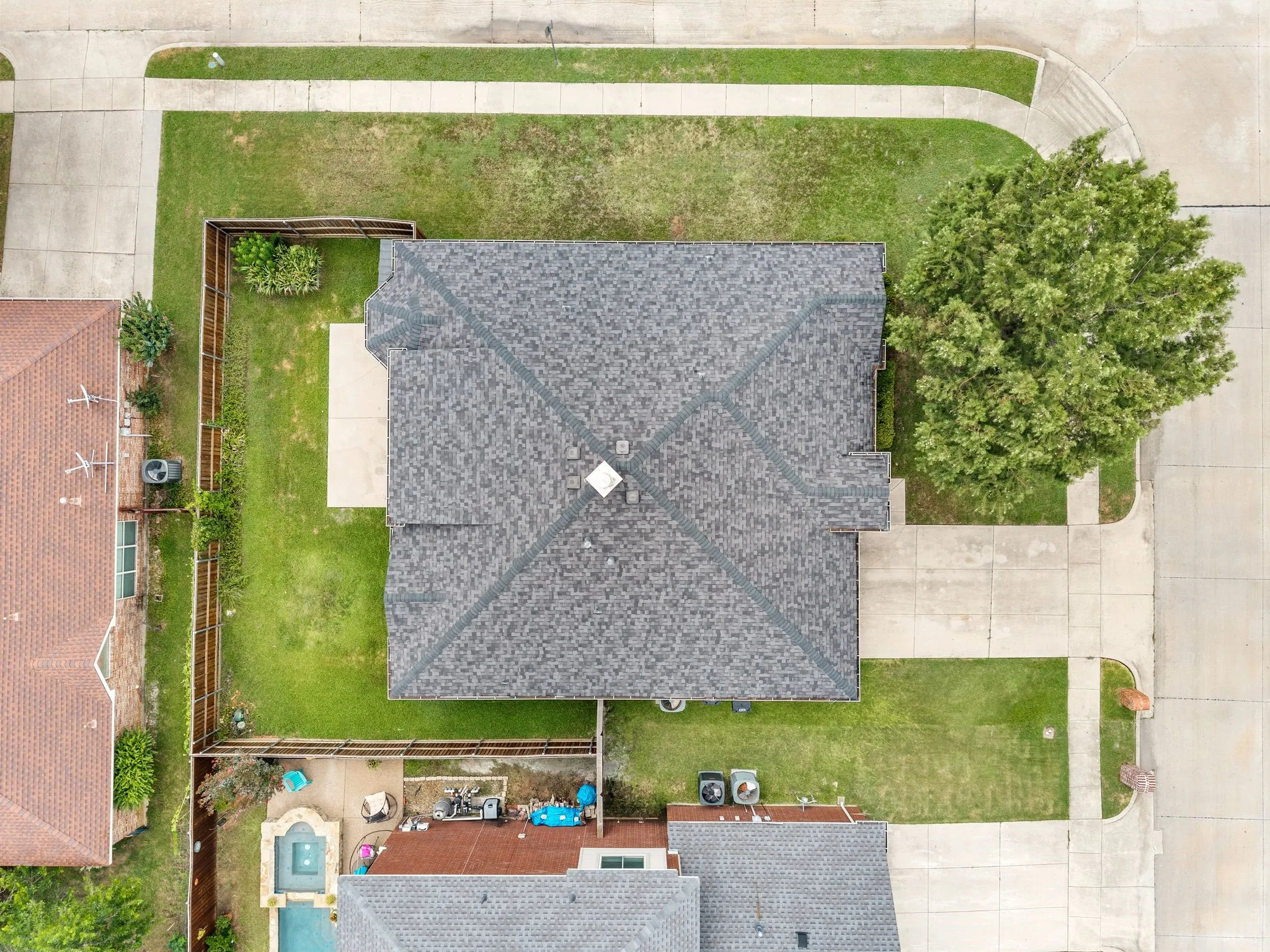 Dark gray architectural shingle roof with a central chimney