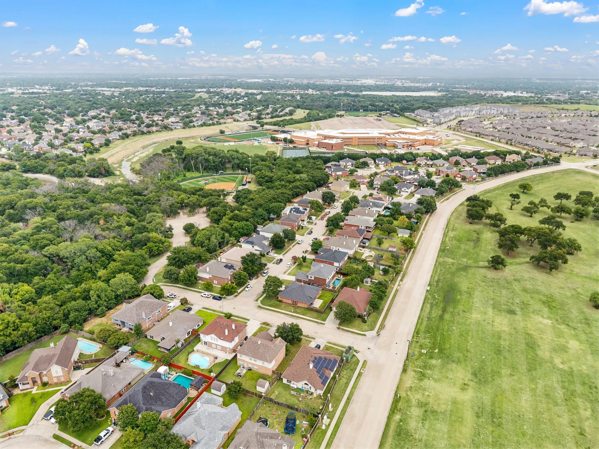Aerial view showcasing a residential neighborhood with private swimming pools
