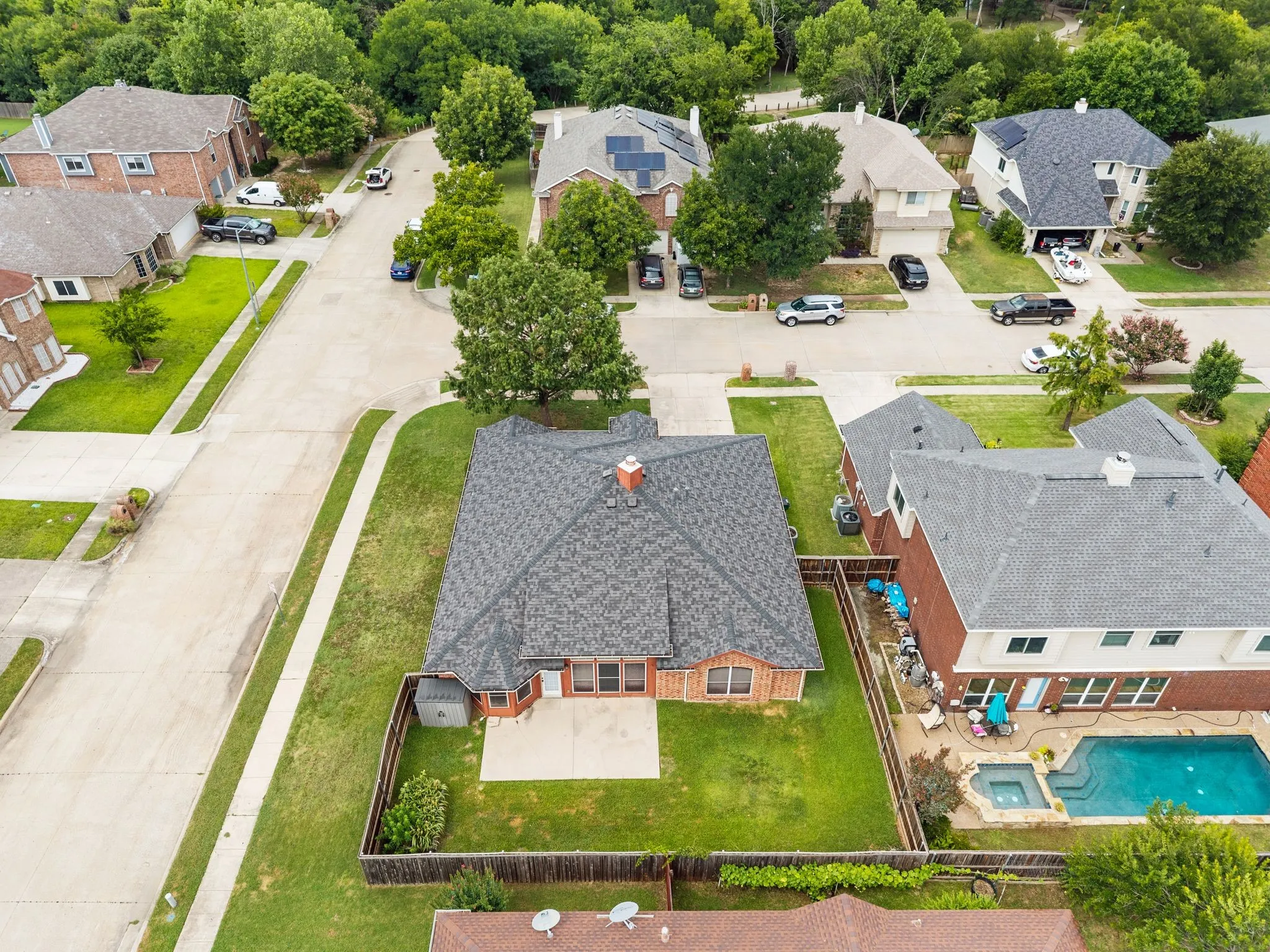 Expansive backyard featuring a manicured lawn, established privacy fencing, and a concrete patio