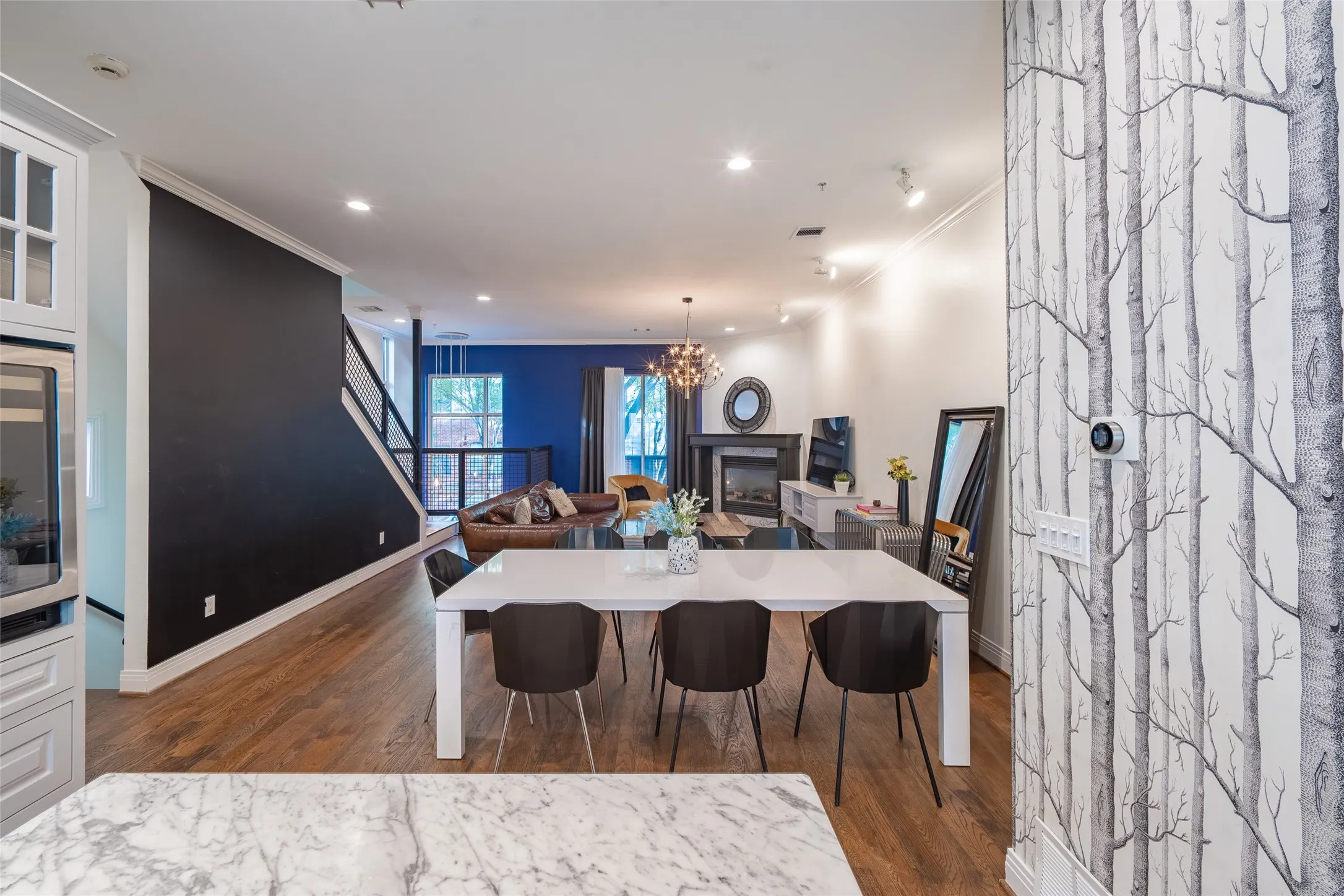 Open concept living and dining area featuring wood-finish flooring