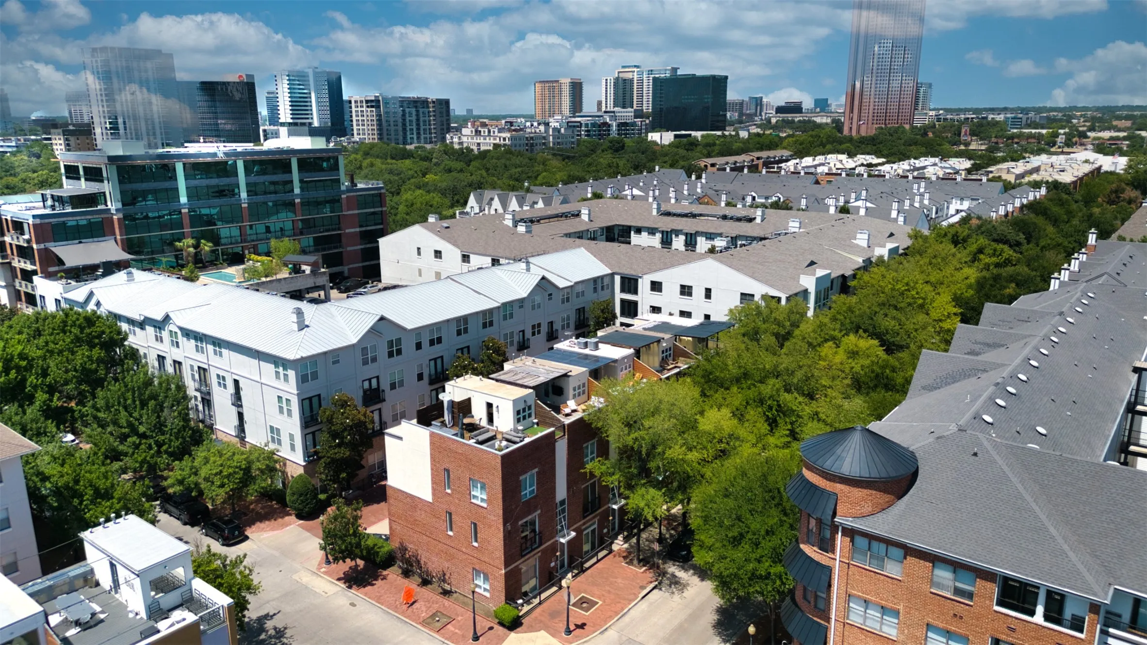 Aerial view showcasing urban density with a mix of residential structures and a distant city skyline