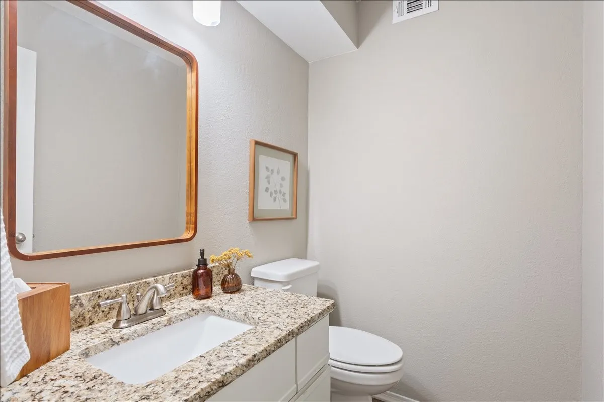 Convenient downstairs half bath located near the main living areas for easy guest access.
