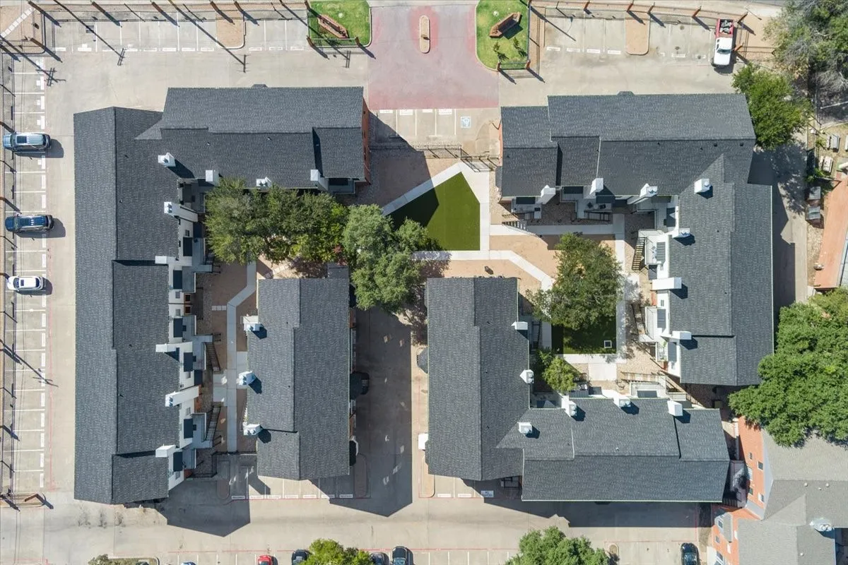 Aerial view of the well-maintained community, showcasing the private gated courtyard and resident parking.