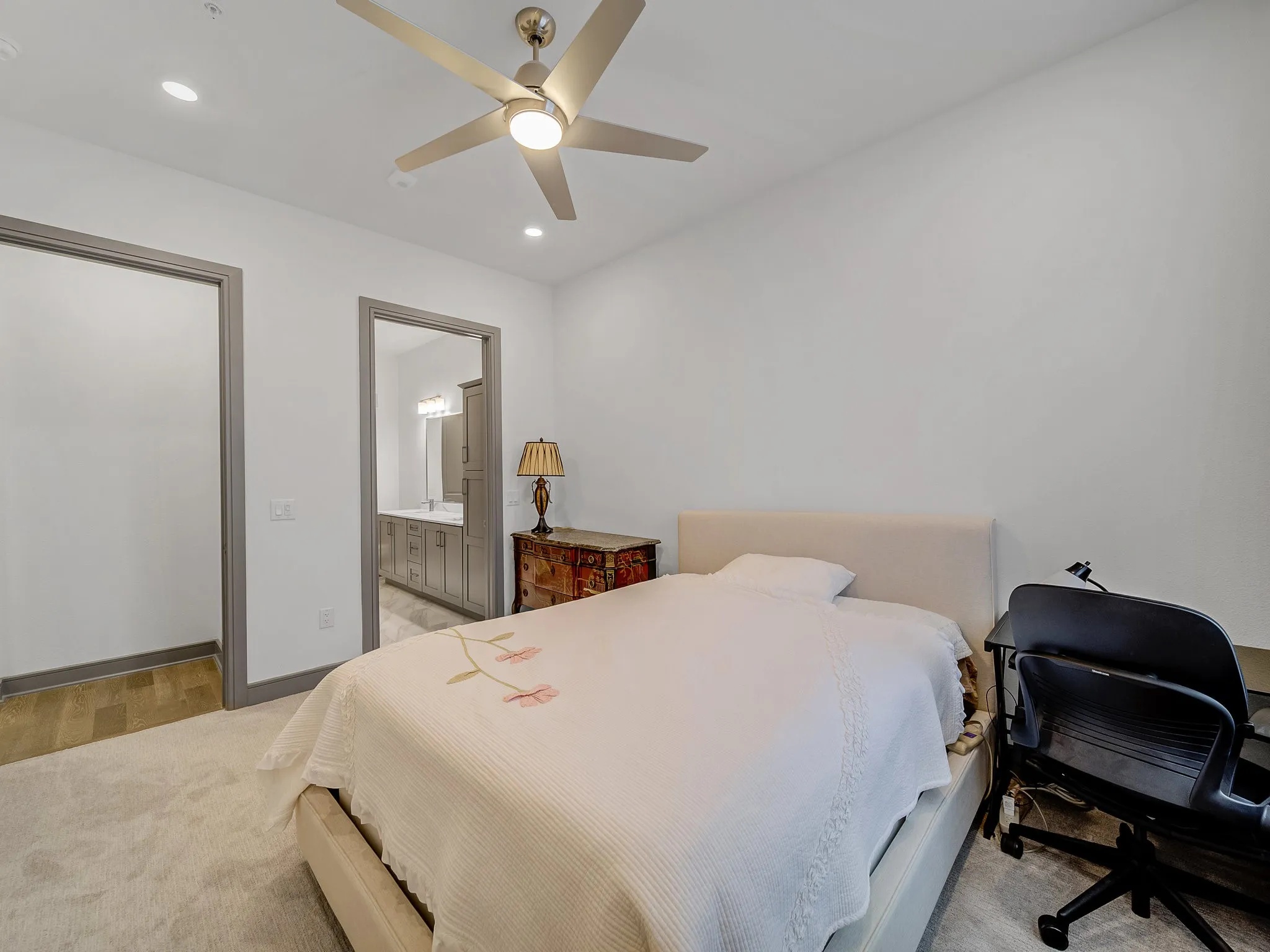 Carpeted room featuring a ceiling fan with integrated lighting, recessed lighting, and a neutral color palette