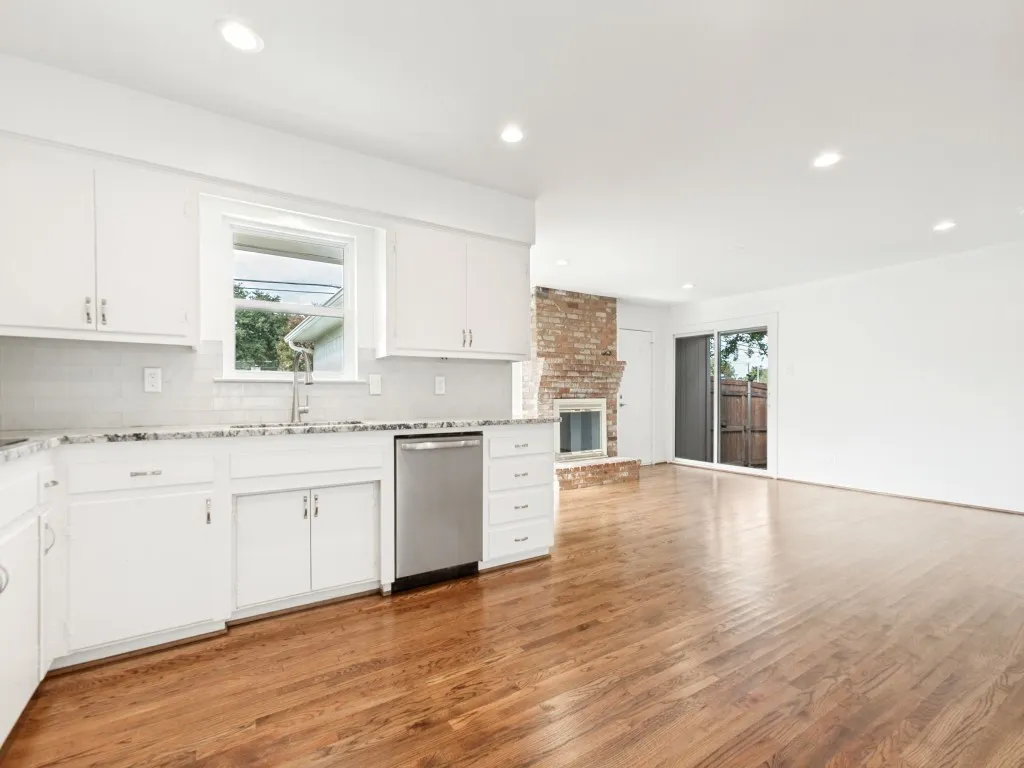 Modern kitchen with white cabinetry and granite countertops