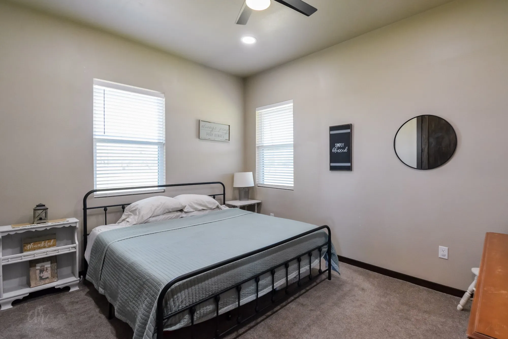 Neutral tone walls complement the dark baseboard trim and textured carpeting