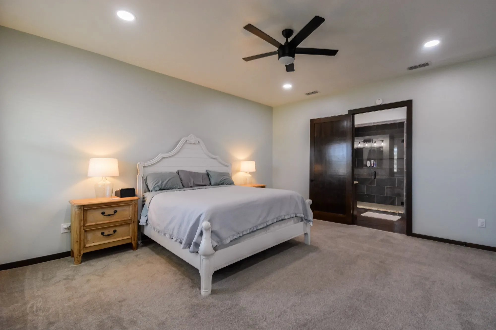 Spacious room featuring light-colored walls and soft carpet flooring
