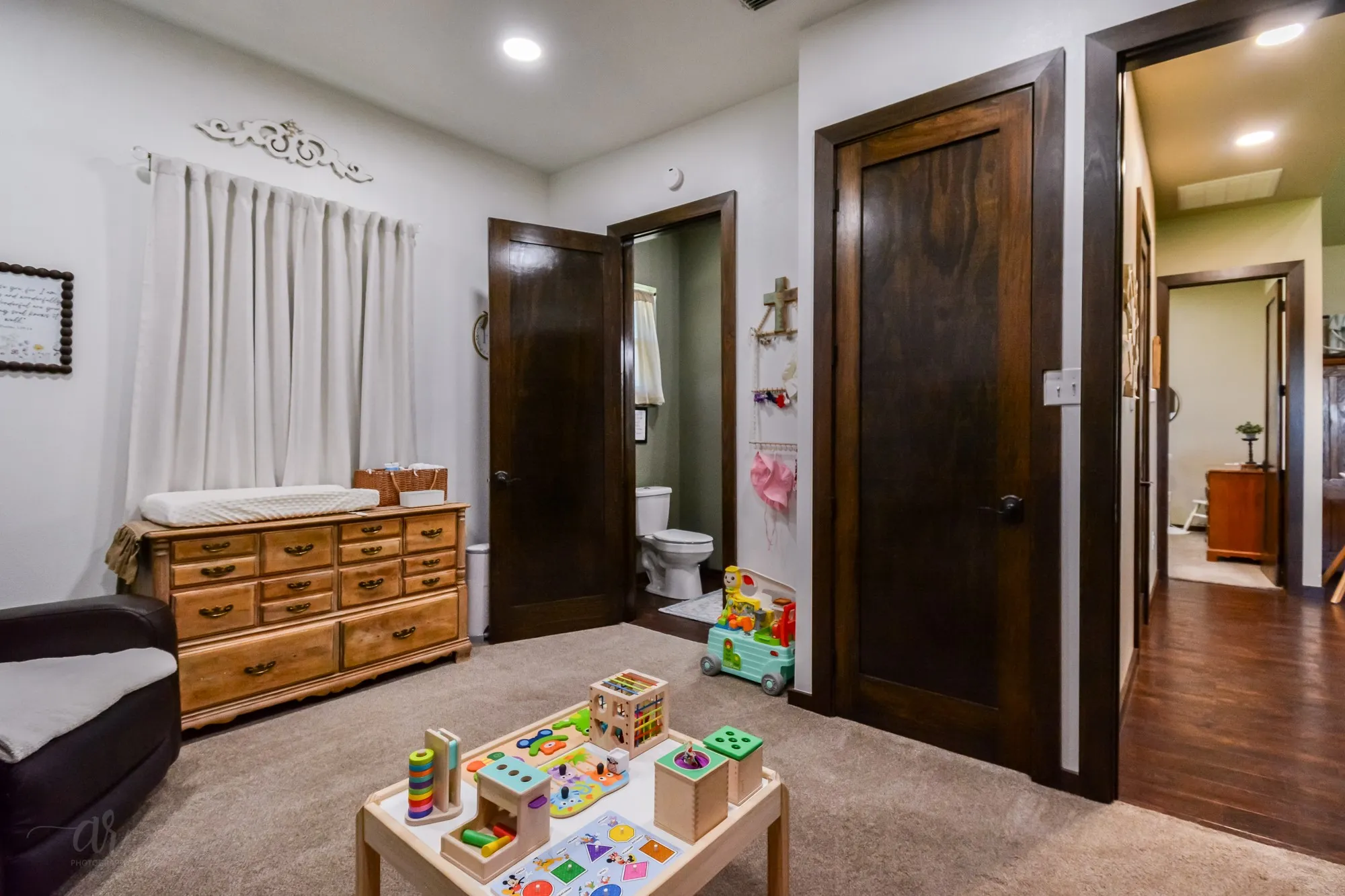 Carpeted room with recessed lighting and dark wood-finish doors