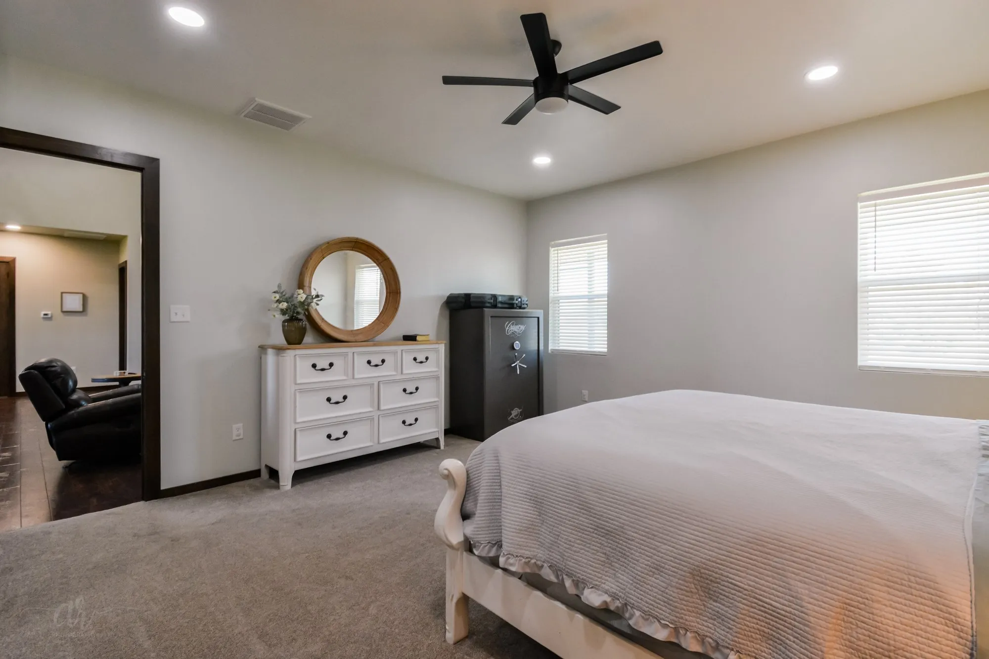 Carpeted bedroom featuring a ceiling fan, recessed lighting, and two windows with blinds