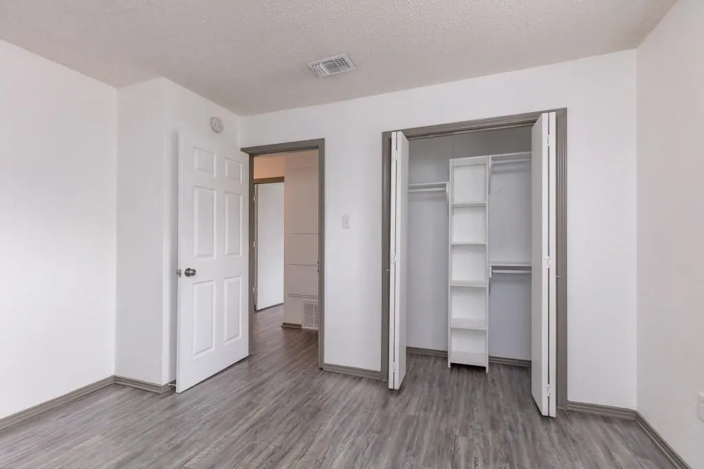 Interior room featuring wood-finish flooring and white walls