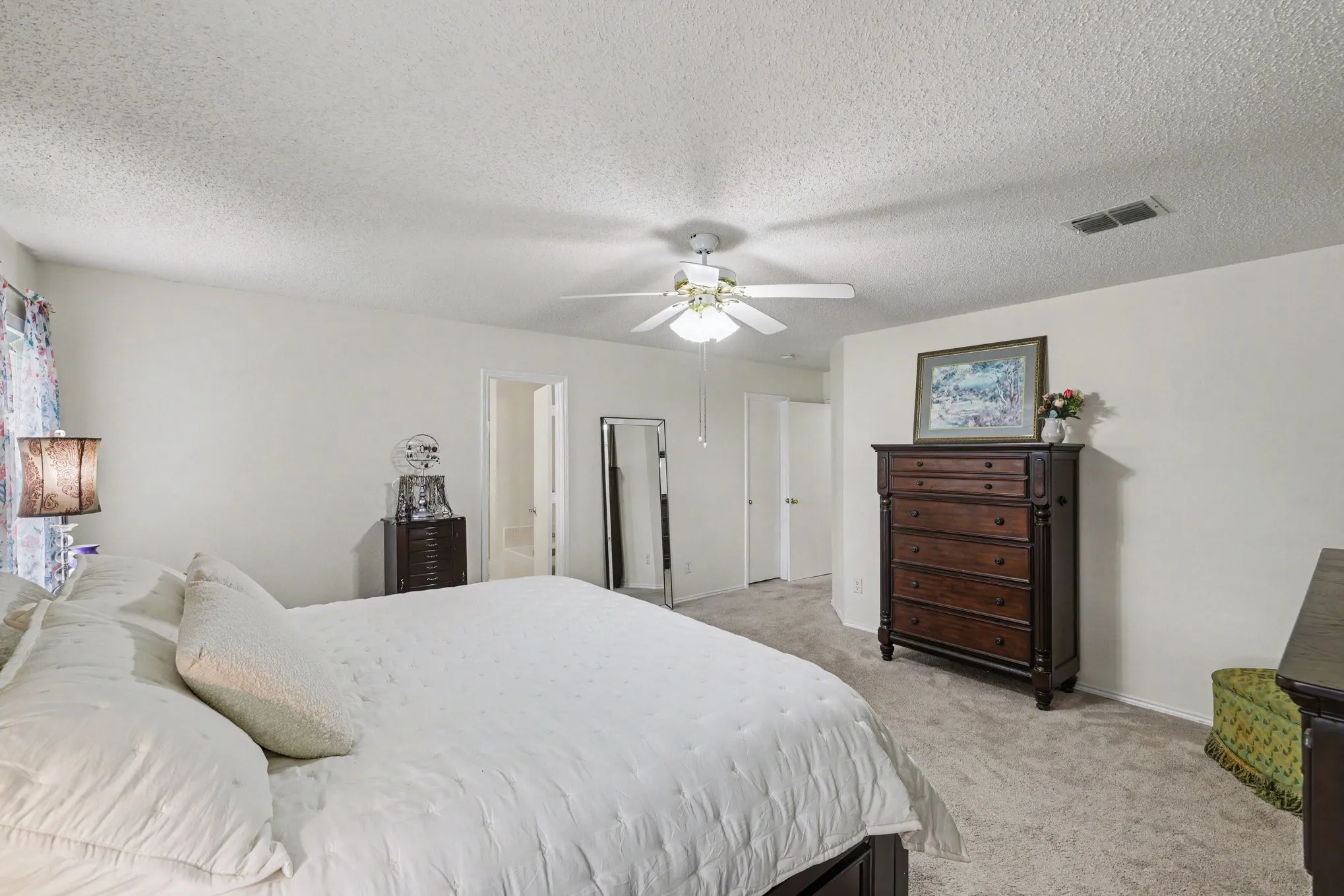 Primary bedroom with ensuite bath and walk-in closet