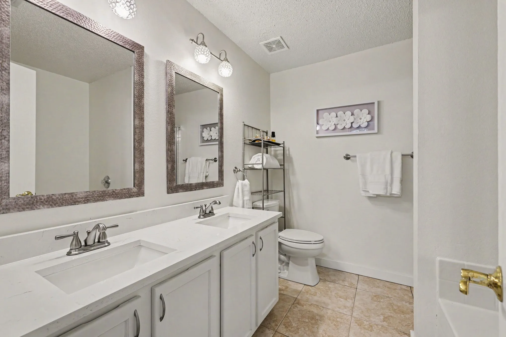 Primary bathroom with separate sinks, quartz counters