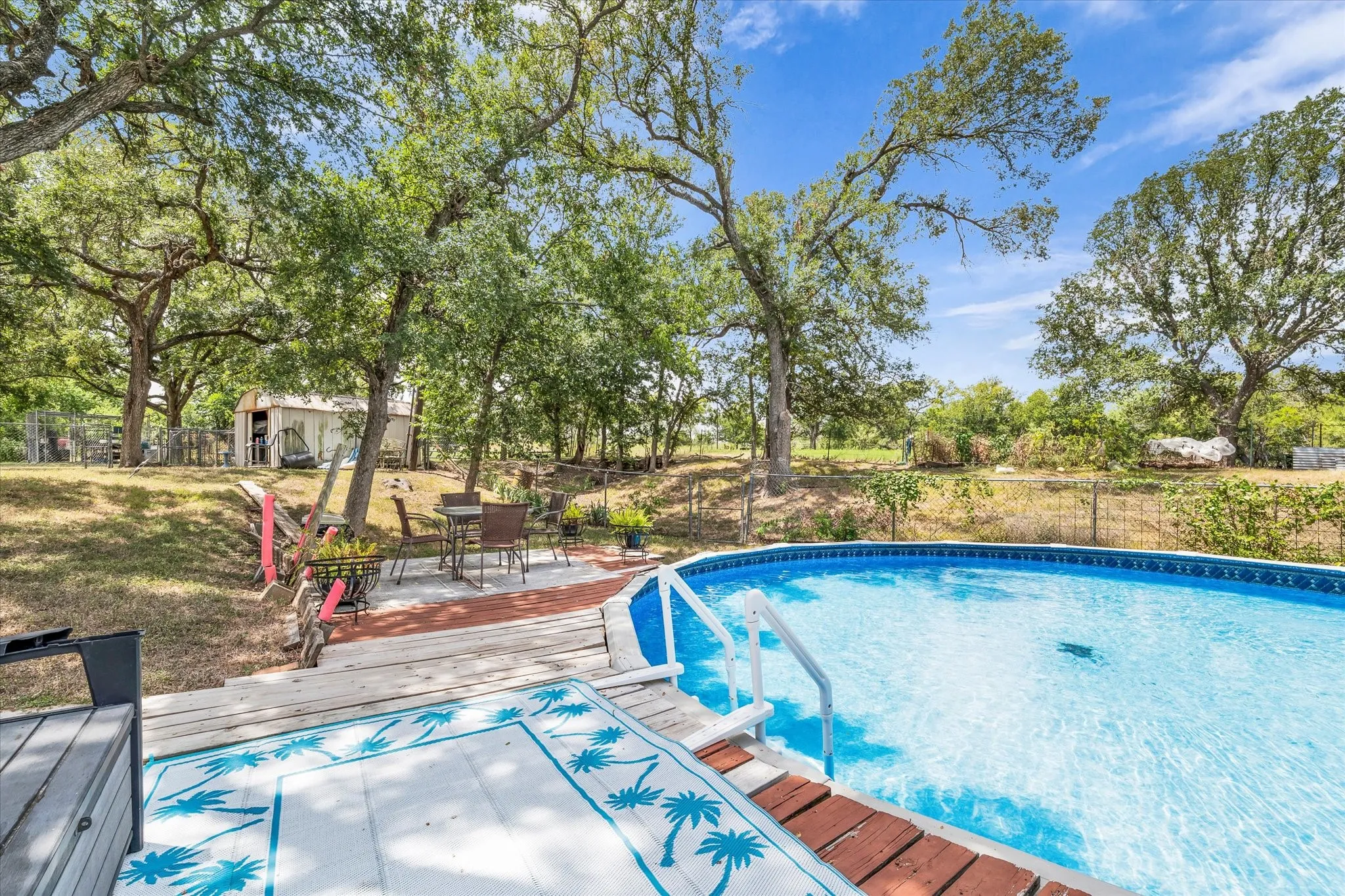 Above-ground swimming pool with deck surround