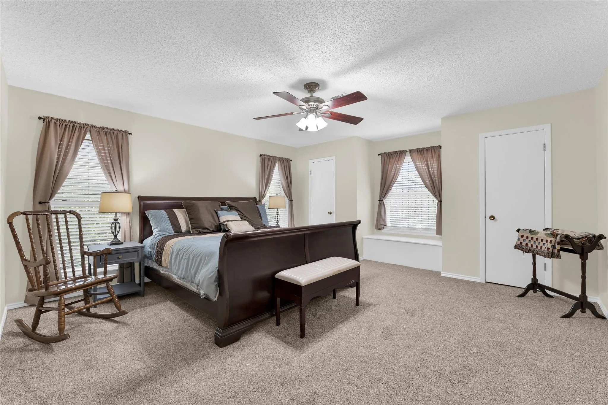 Spacious bedroom featuring plush carpeting and neutral wall tones